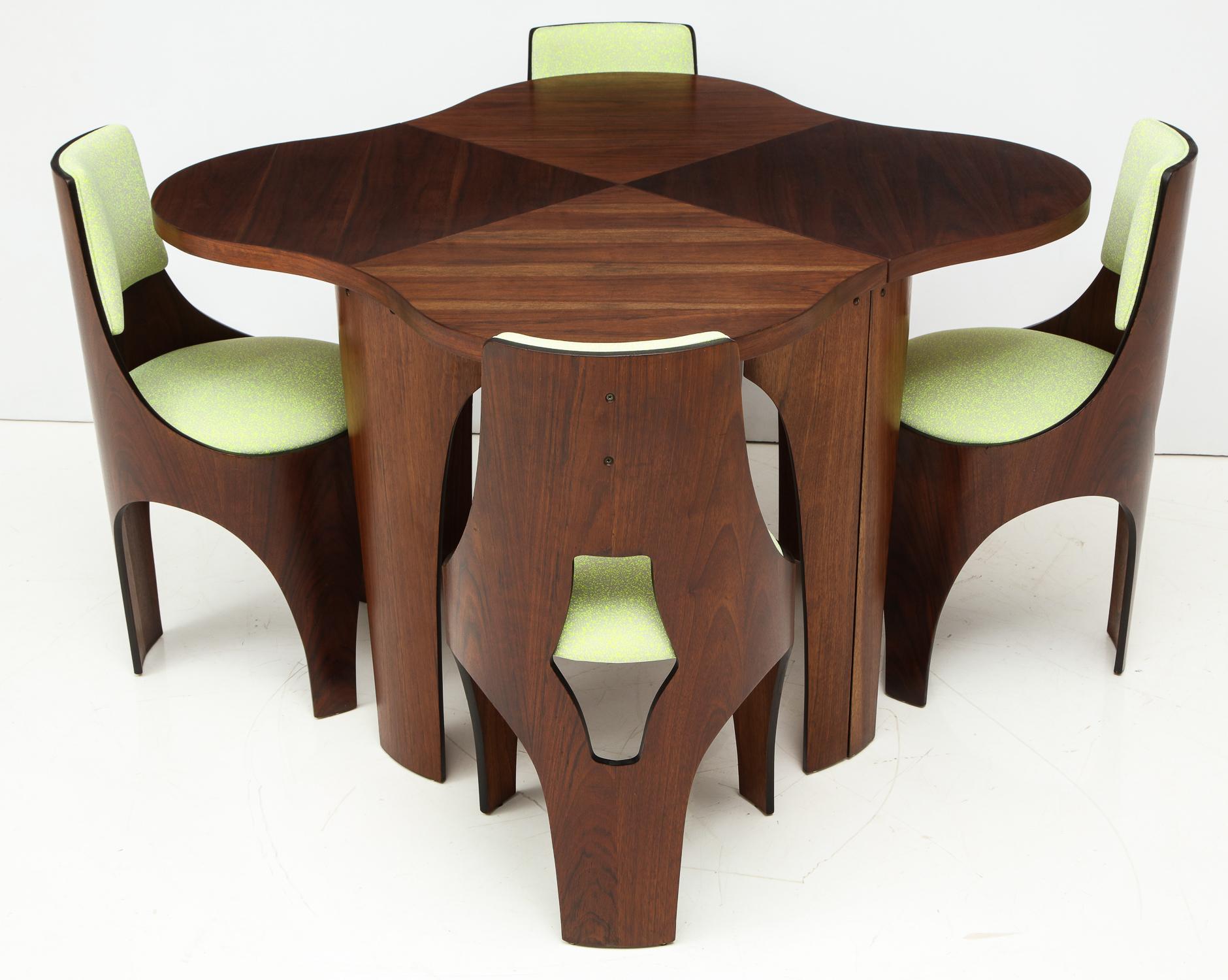 Table and four chairs of walnut and walnut plywood from the Cylindra line designed by Henry Glass and produced by Richbilt Mfg, circa 1966. Born in Vienna and trained in Industrial design and architecture there, Glass emigrated to the U.S. in 1939,