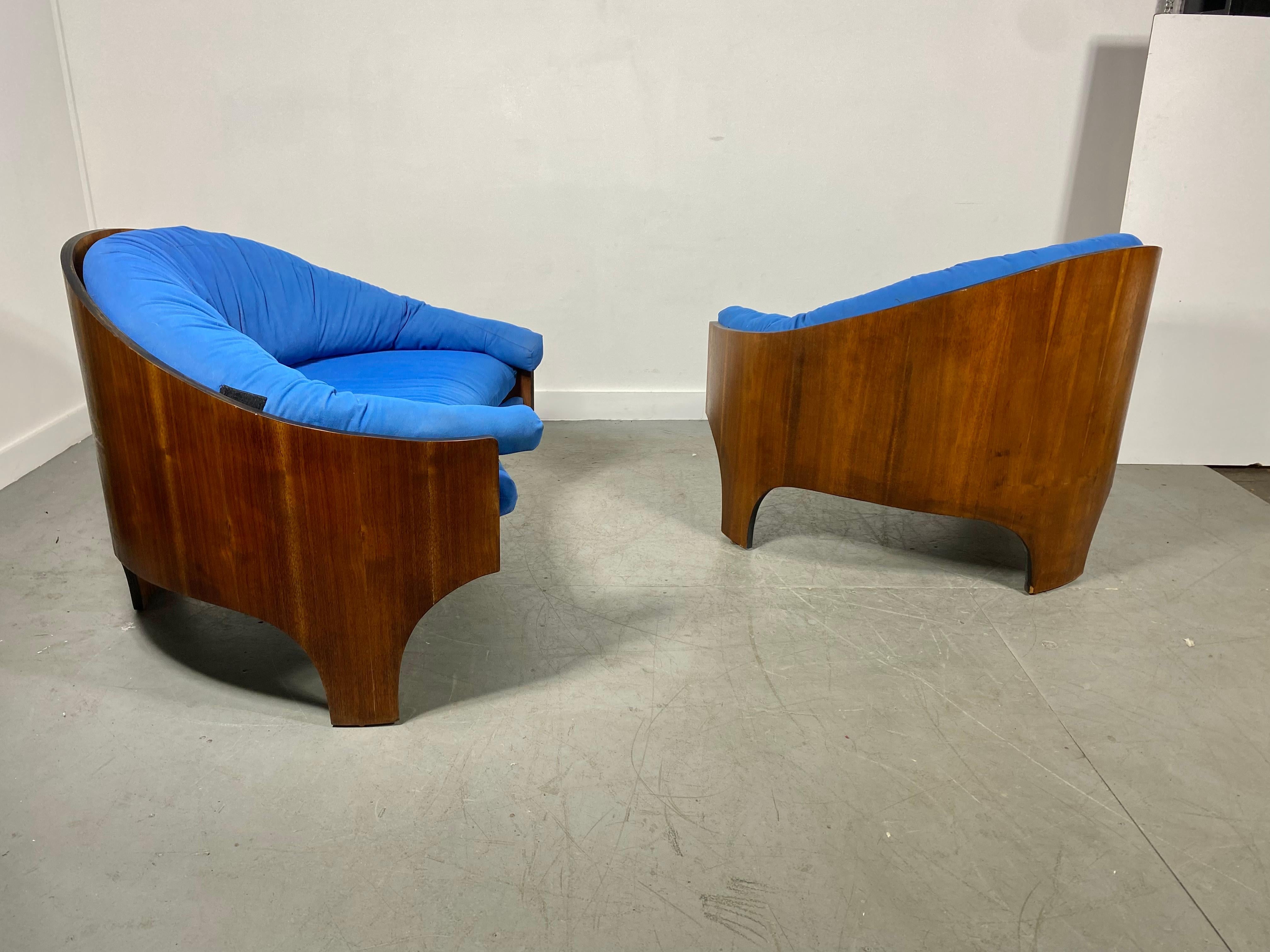 
Stunning pair Intimate Island Lounge Chairs designed by Henry Glass c. 1964.retain original finish , patina. minor veneer loss..(bottom inner edge)..Reupholstered at some point in a blue fabric.. in need of a good cleaning..Extremely comfortable.