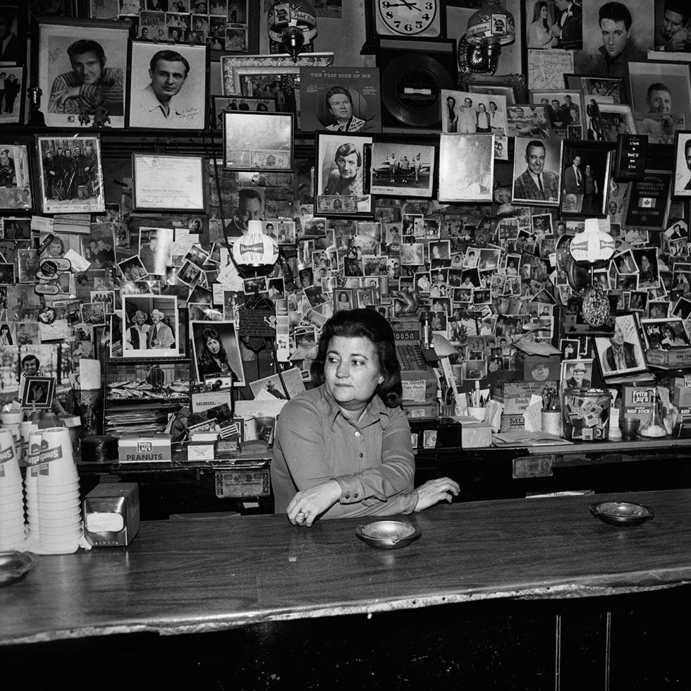 Henry Horenstein Portrait Photograph - Wanda Behind the Bar