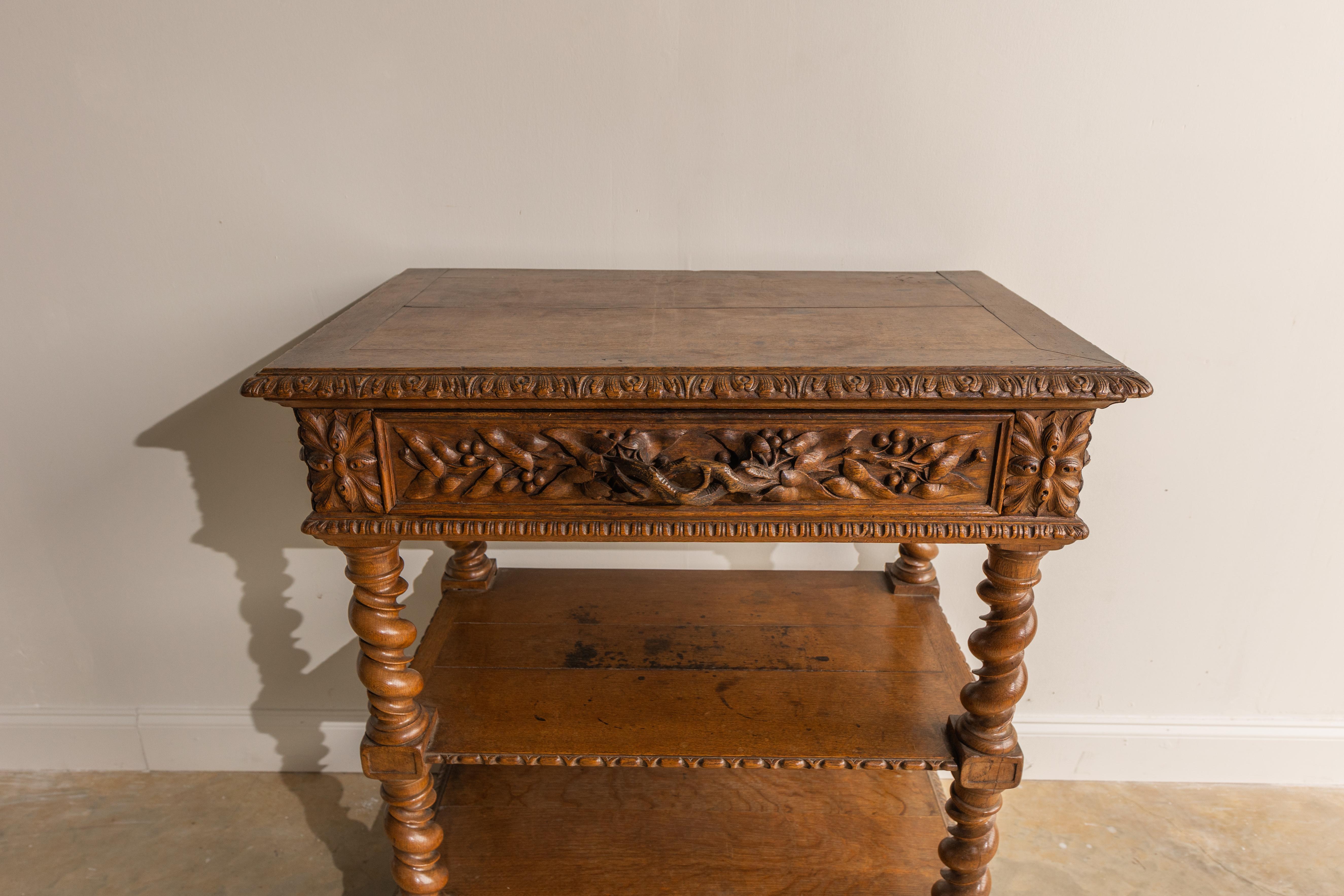 There are so many unique details to this Henri II Oak Console Table. The dark stain is truly stunning and gives this piece such a rich feel. There is a top central drawer with a very unique carved drawer pull. There are two sturdy shelves as well.