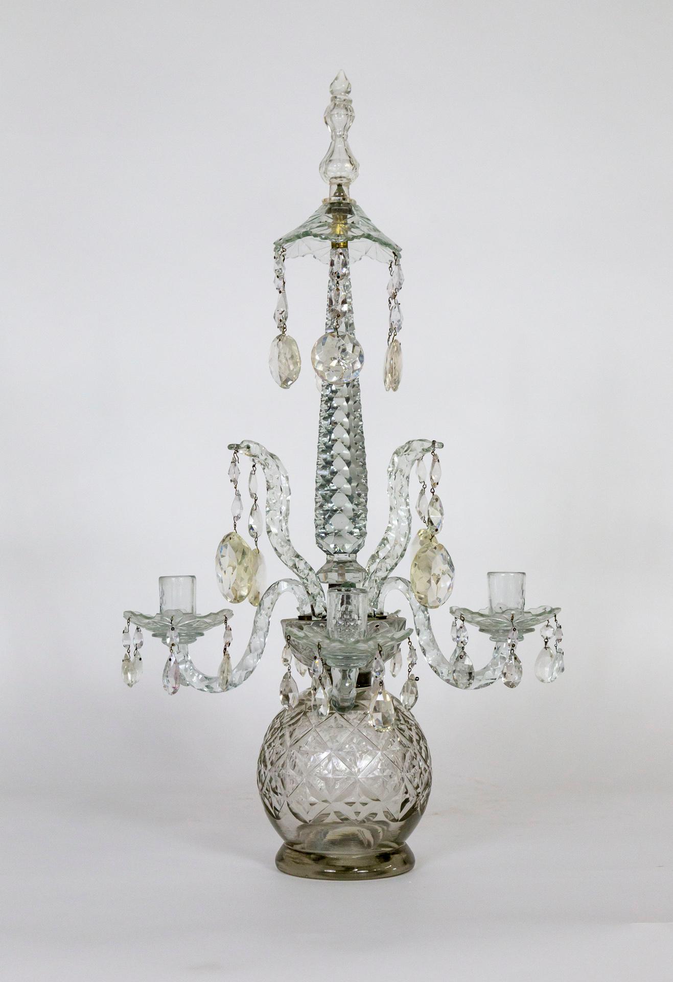 This large, ornate, tabletop candelabra holds 4 candles and is a stunning work of art with or without them. From 19th century Ireland in Henry III style; and made entirely of cut crystal with a large sphere base under a bowl mount with four snakes
