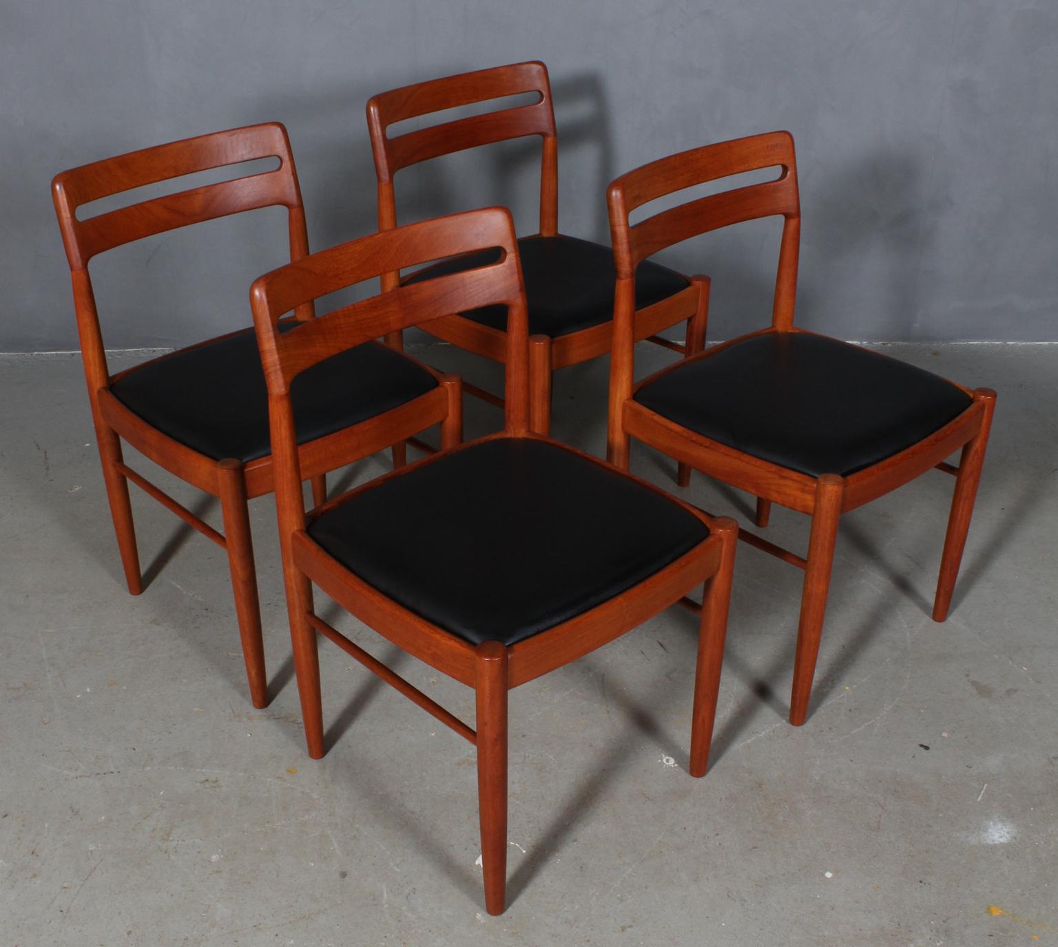 Henry Walter Klein four dining chairs in solid teak.

New upholstered with black aniline leather.

Made by Bramin, 1960s.