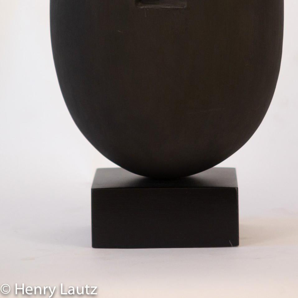 This minimalist, Zen like sculpture is formed from Linden wood, also known as Basswood, which was considered sacred in Slavic mythology. This sculpture was hand crafted over 300 hours. Oil paint was used. It sits on a steel
base.