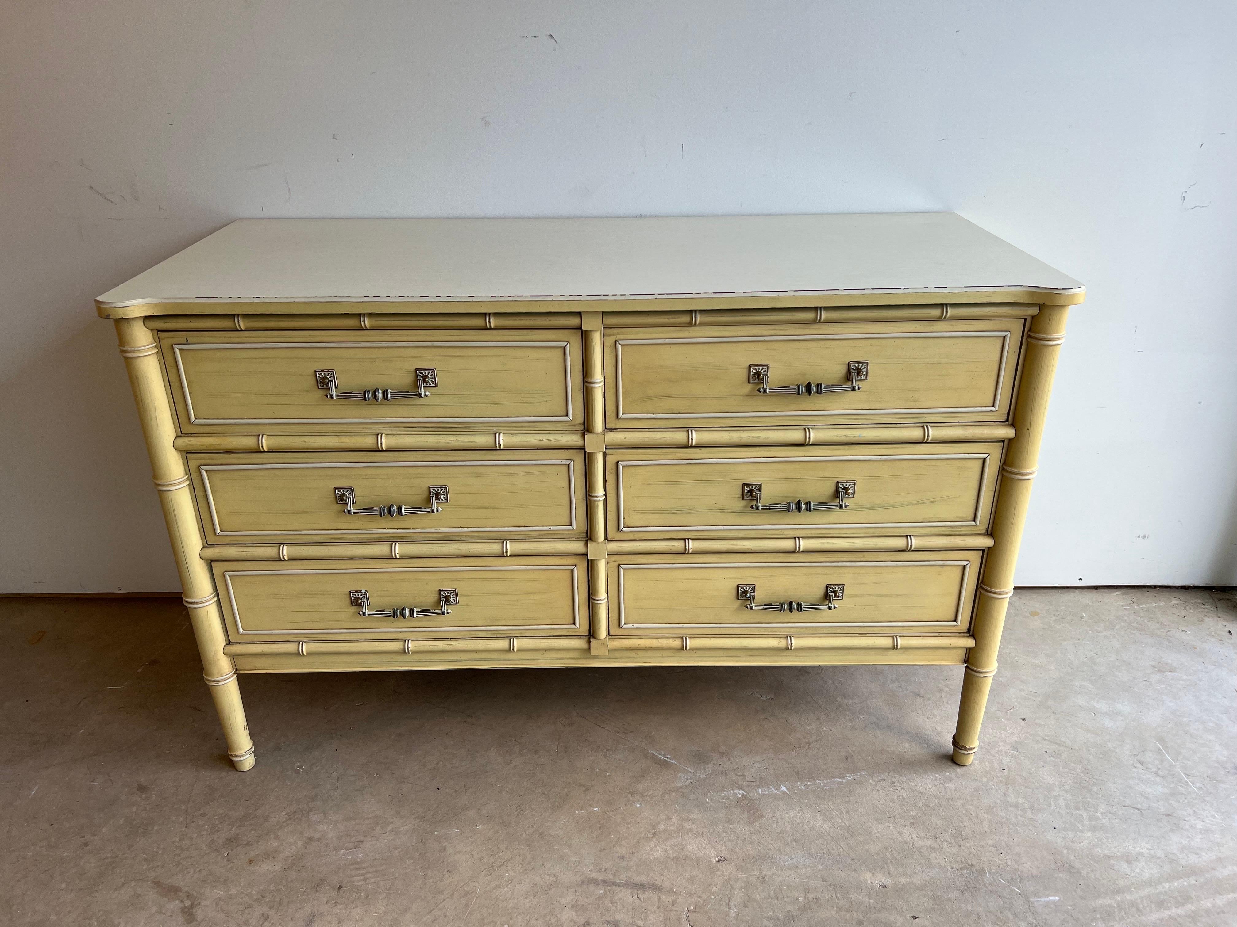 Henry Link Faux Bamboo Dresser in yellow and white. Classic 6 drawer dresser with white laminate top from the Bali Hai collection. Solid wood construction with dovetailed drawers . Nice Faux bamboo accents. Signed in top drawer. Painted finish has