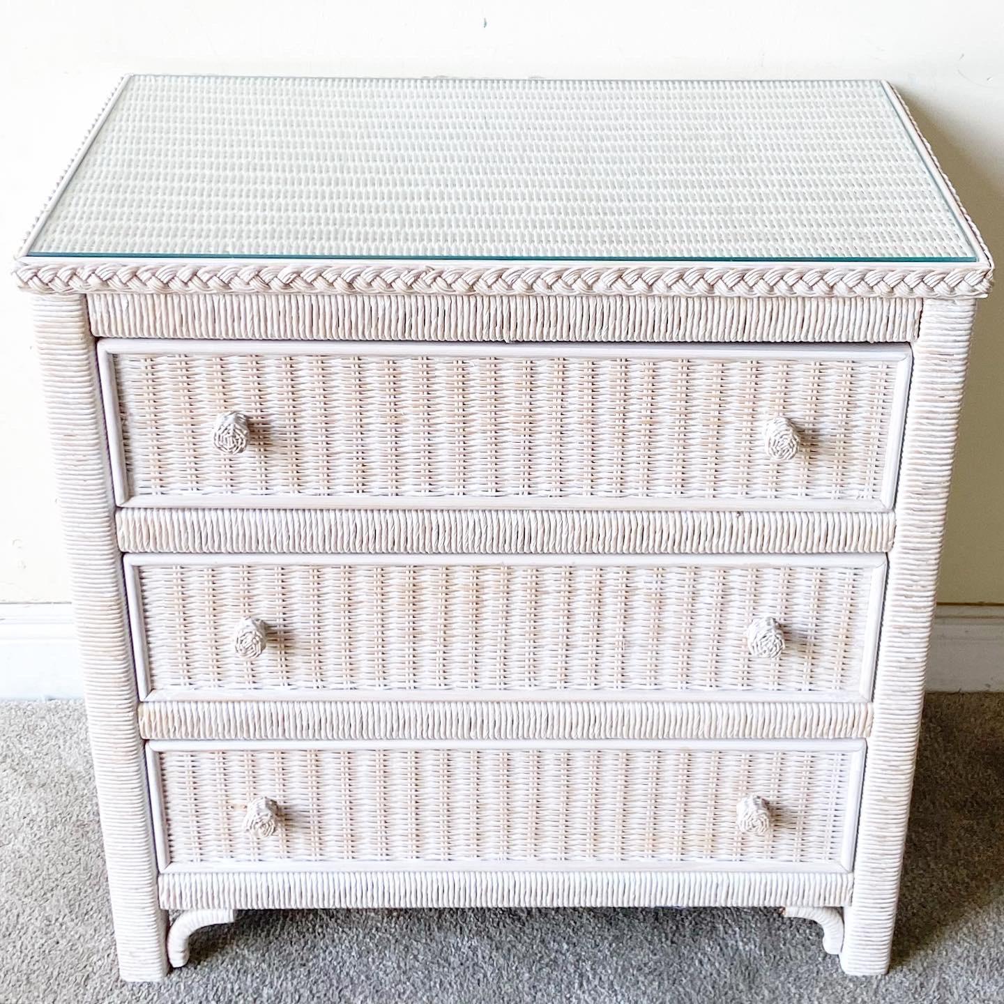 Incredible 3 drawer dresser with a glass top by Henry Link for Lexington furniture Co. Features wicker woven through out with a rattan frame.

