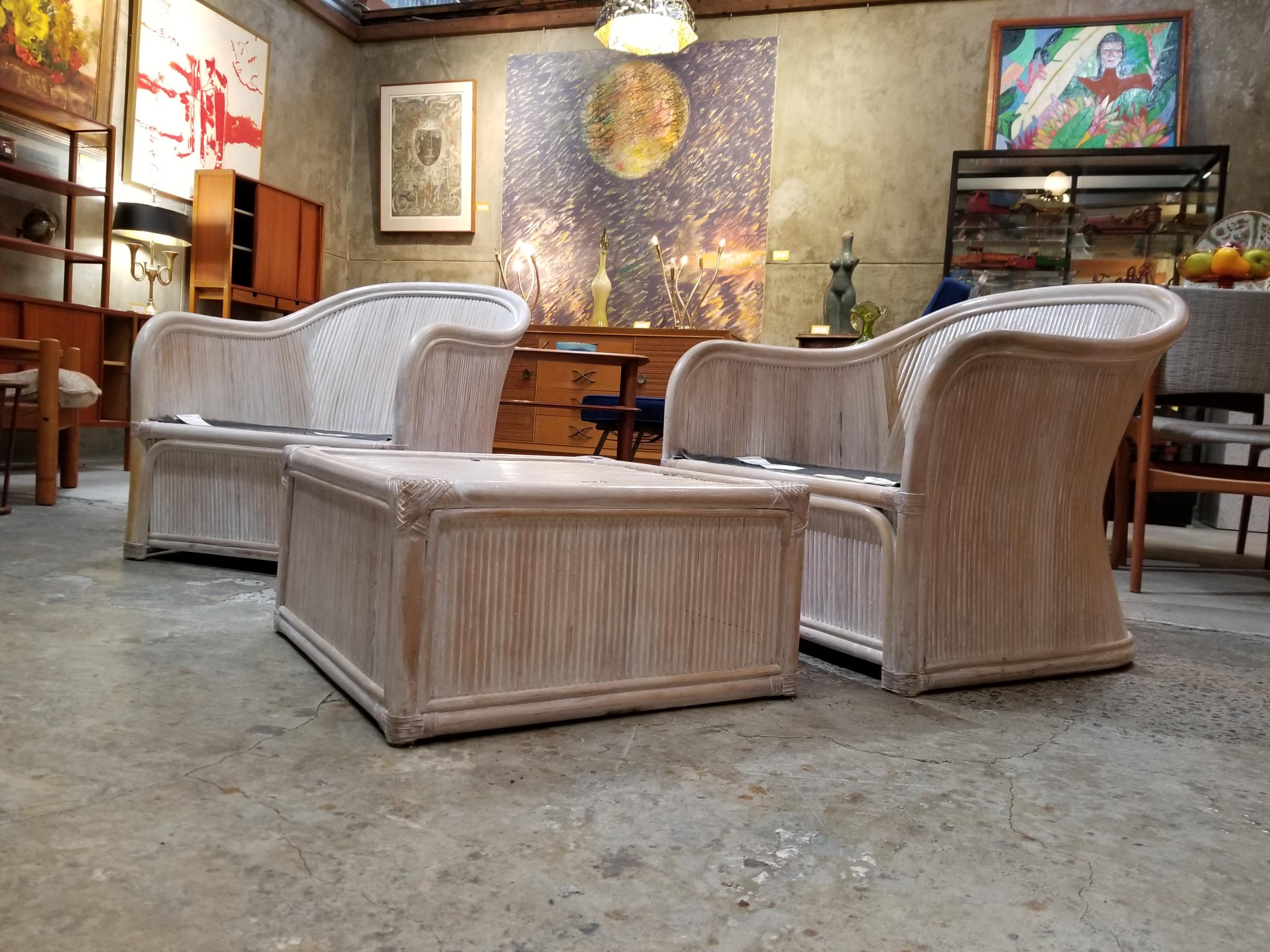 A pair of Henry Link wicker lounge chairs with single ottoman. Sculptural design, structurally very solid. Upholstery is in good condition with some wear, foam is soft and comfortable. Original white-washed finish. Ottoman measures 24