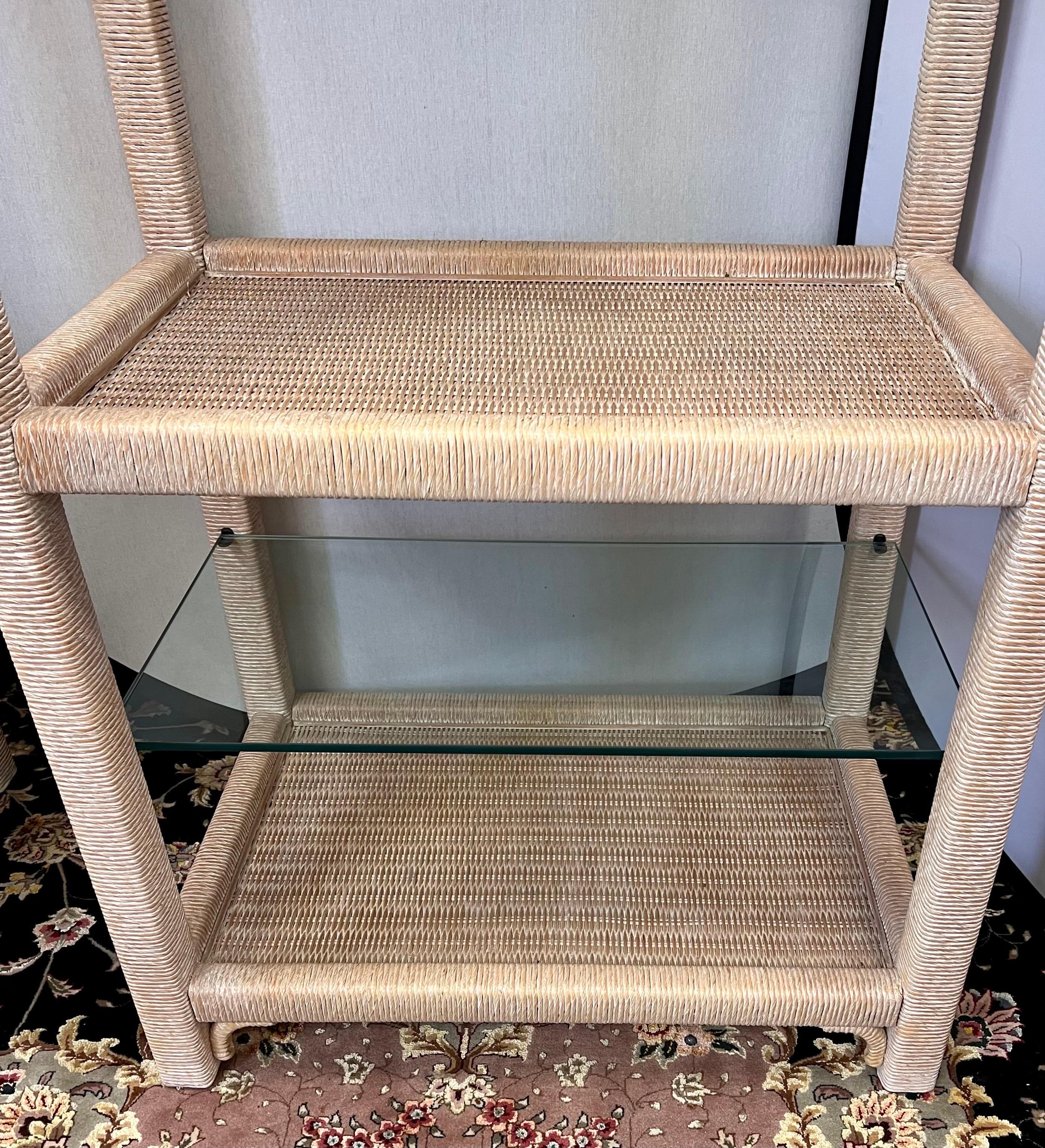 Henry Link wicker wrapped etagere with glass shelves on top. Has light at top to illuminate your collectibles from above.
See our other listings for two more Henry Link etageres.