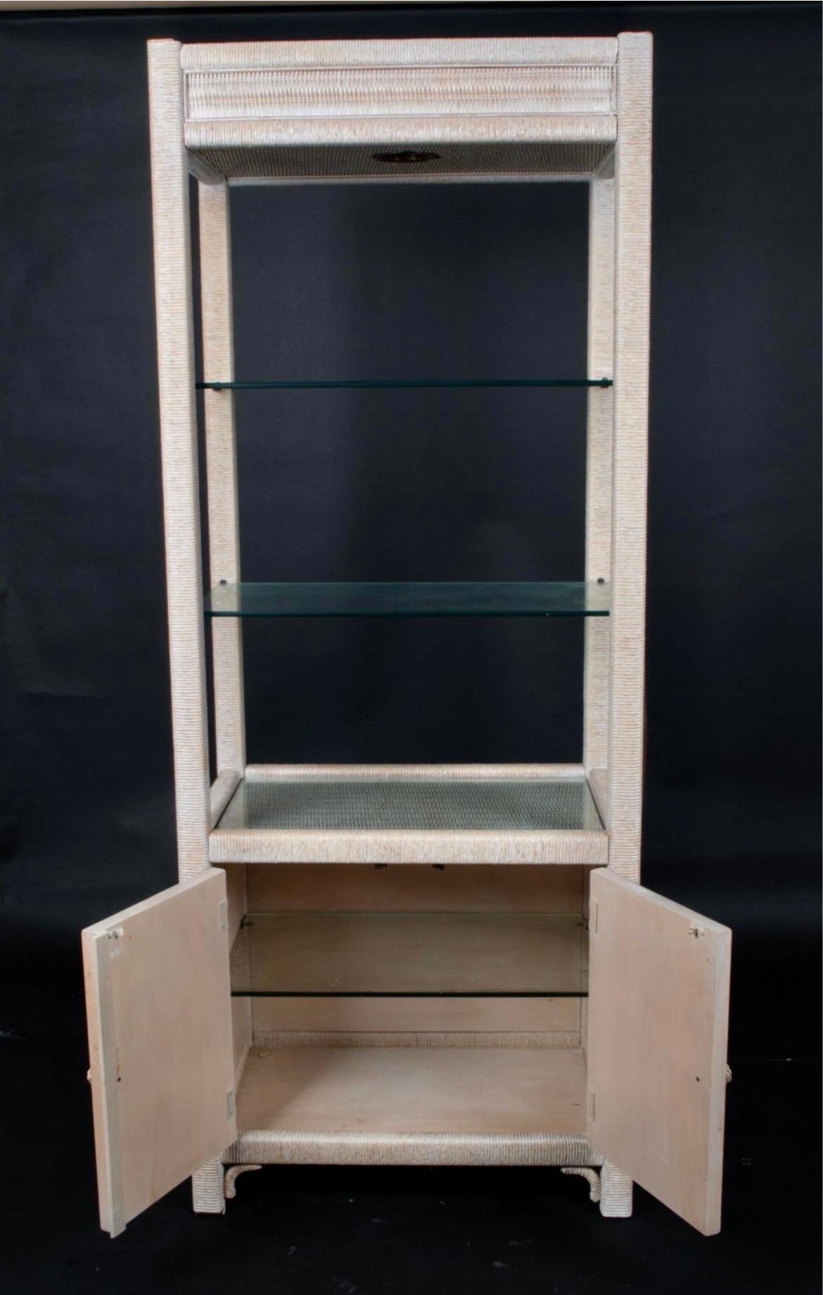 Henry Link wicker wrapped bookcase etagere with a whitewashed finish. Top has glass shelves. Bottom part has three drawers.
See our other listings for two more etageres.