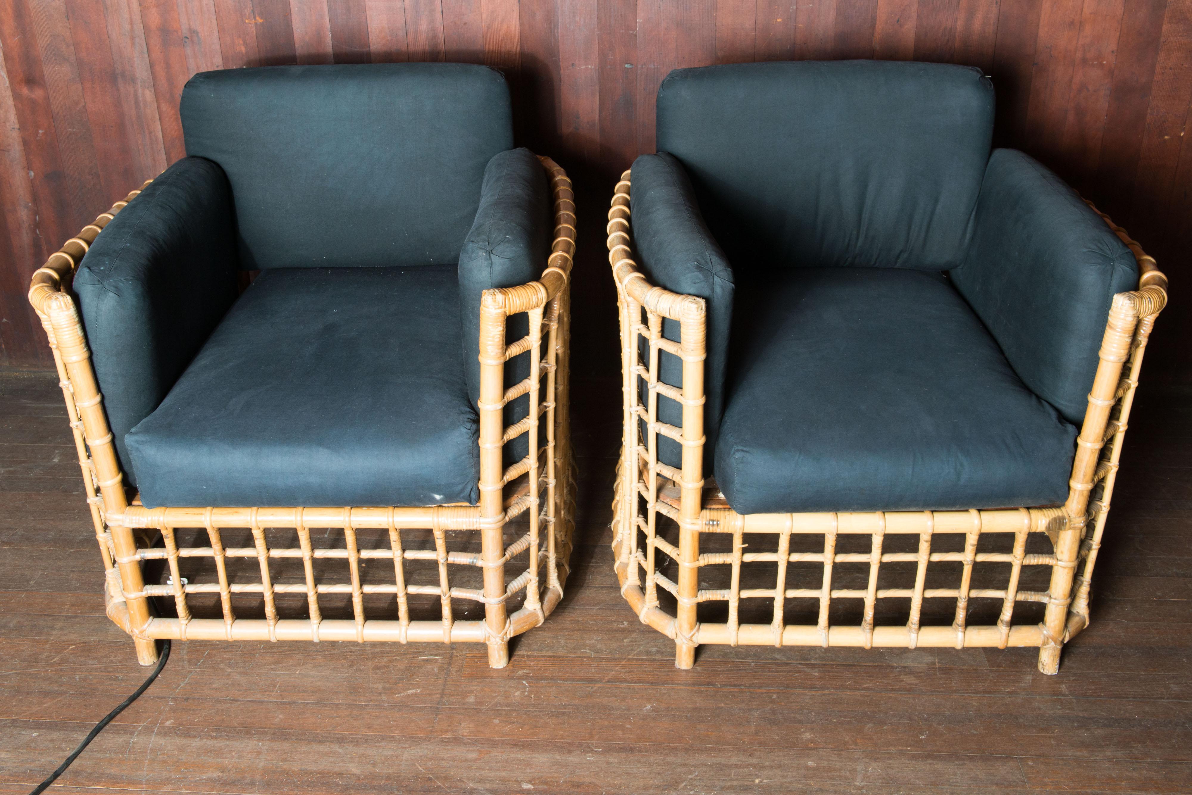 An exquisite and rare pair of rattan chairs by well known Henry Olko for his Willow and Reed company, circa 1975. These unique chairs are from Olko's Square series. - Substantial and sturdy rattan and hardwood construction with precision cane