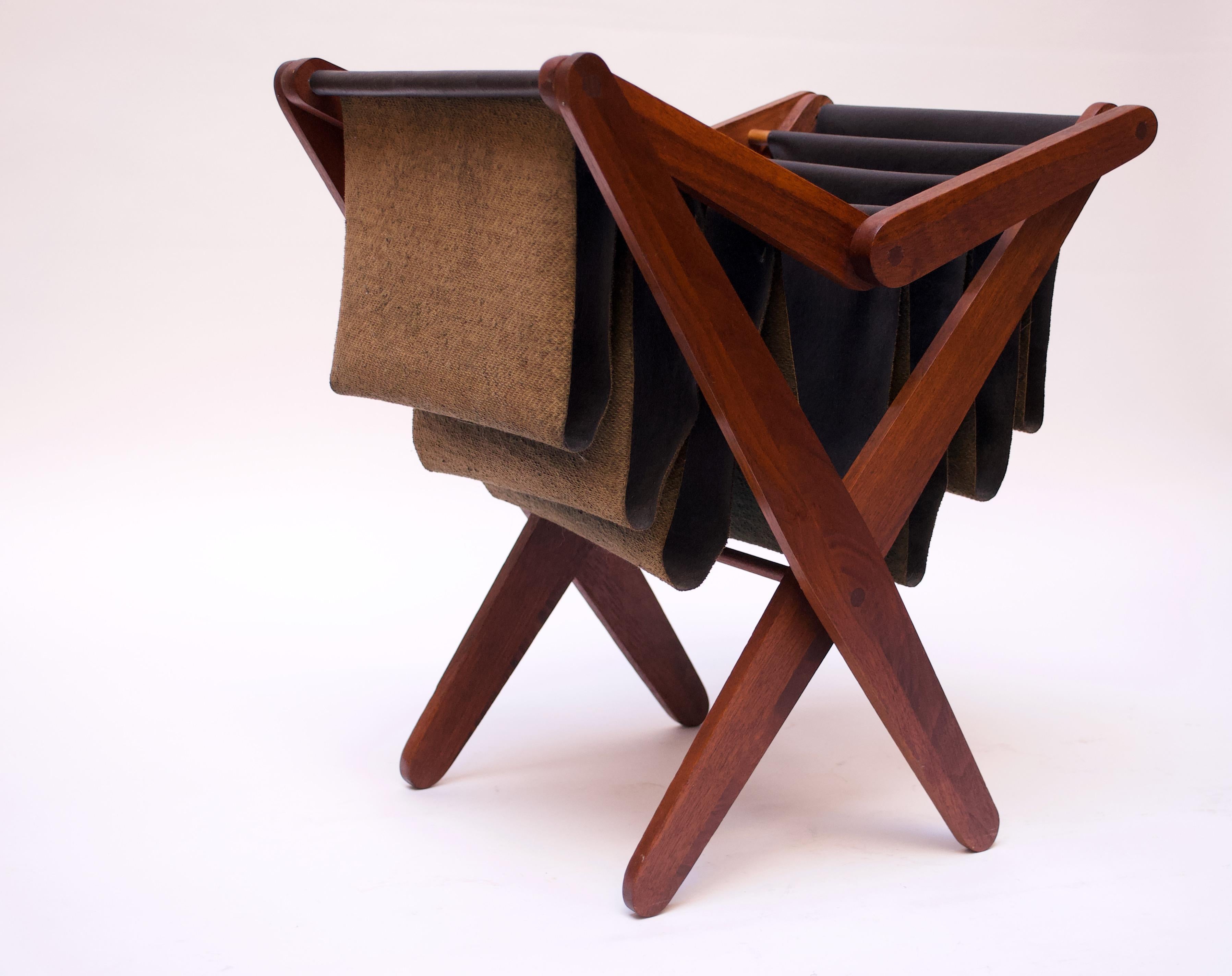Attractive Henry P. Glass magazine rack with sculpted walnut legs assembled using sophisticated wood joinery techniques (circular joints). Slots are made of Naugahyde (original to the design).
Despite its appearance, the piece is not totally
