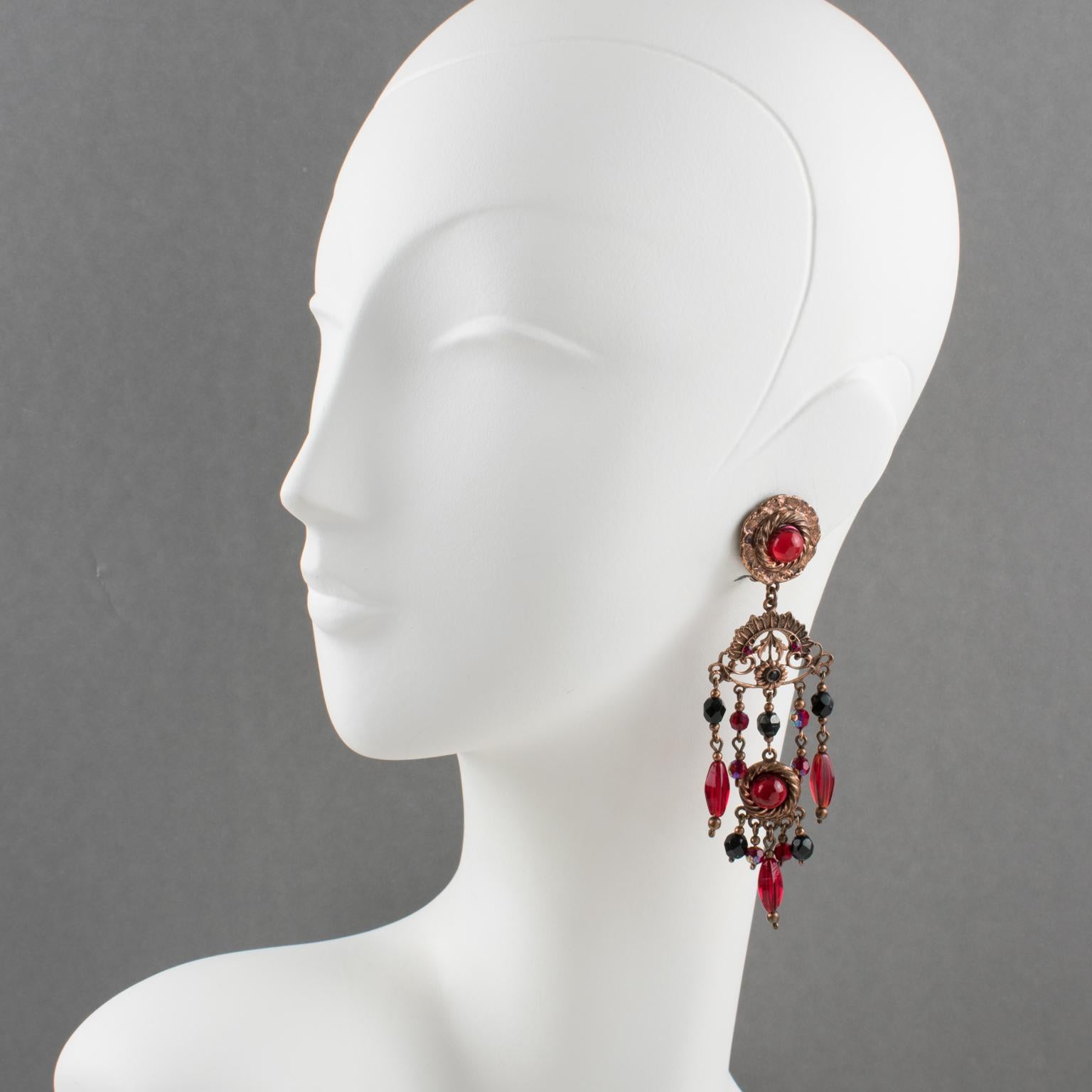 These fabulous French Jewelry designer Henry Perichon (aka Henry) baroque clip-on earrings boast a copper finish metal extra long dangling shape in a Victorian design inspiration ornate with red and black faceted crystal beads and ruby red poured