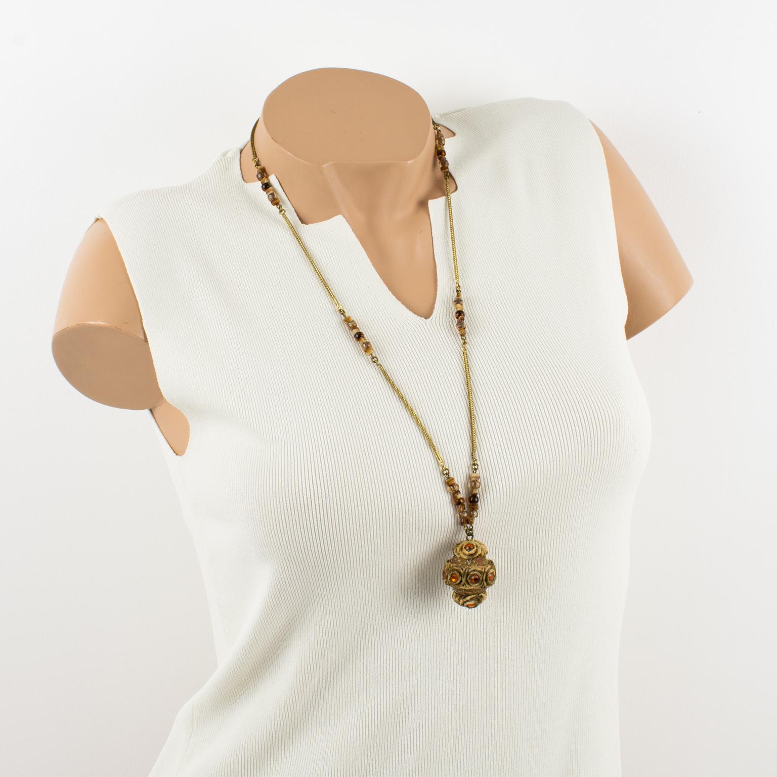 French jewelry artist Henry Perichon (aka Henry) designed this elegant brass and Talosel resin necklace in the 1960s. The long necklace features a brown-beige Talosel resin ball pendant topped with topaz orange crystal faceted rhinestones. The