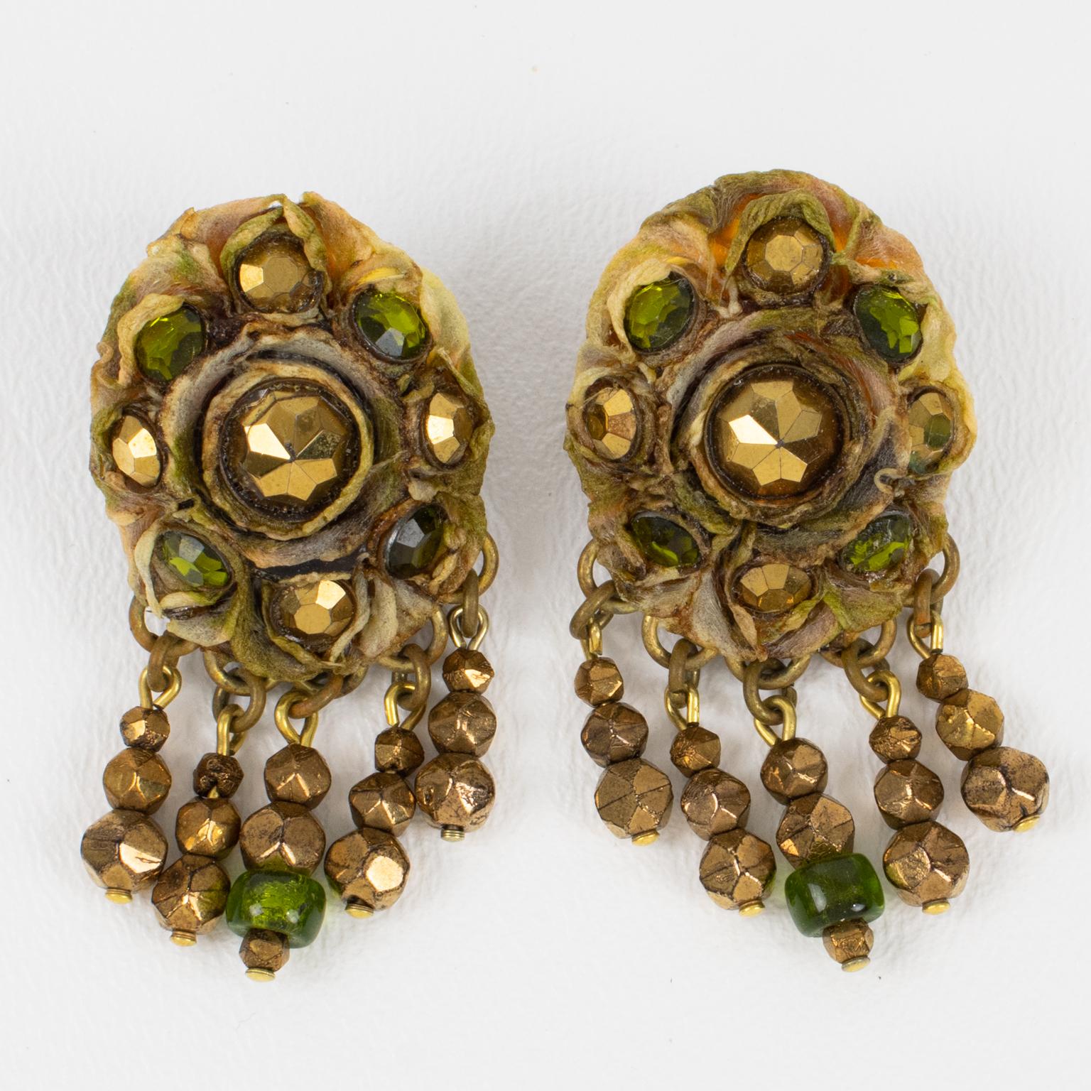 French jewelry artist Henry Perichon (aka Henry) designed these stunning Talosel resin clip-on earrings in the 1960s. These rare pieces feature a brown-beige Talosel resin frame topped with metallic bronze and green glass faceted cabochons,