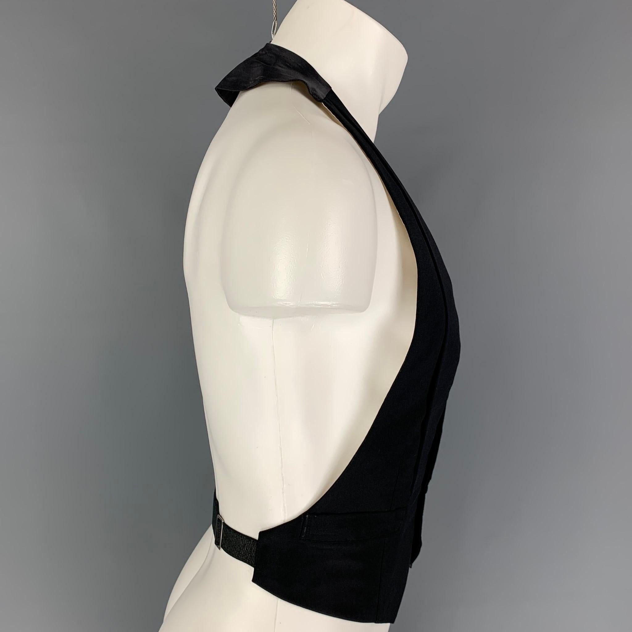 Custom Made HENRY POOLE & Co. of Savile Row tuxedo vest comes in a black silk featuring a shawl lapel style, slit pockets, open back, and a buttoned closure. Made in England.

Excellent Pre-Owned Condition. Fabric tag removed.
Marked: Size tag