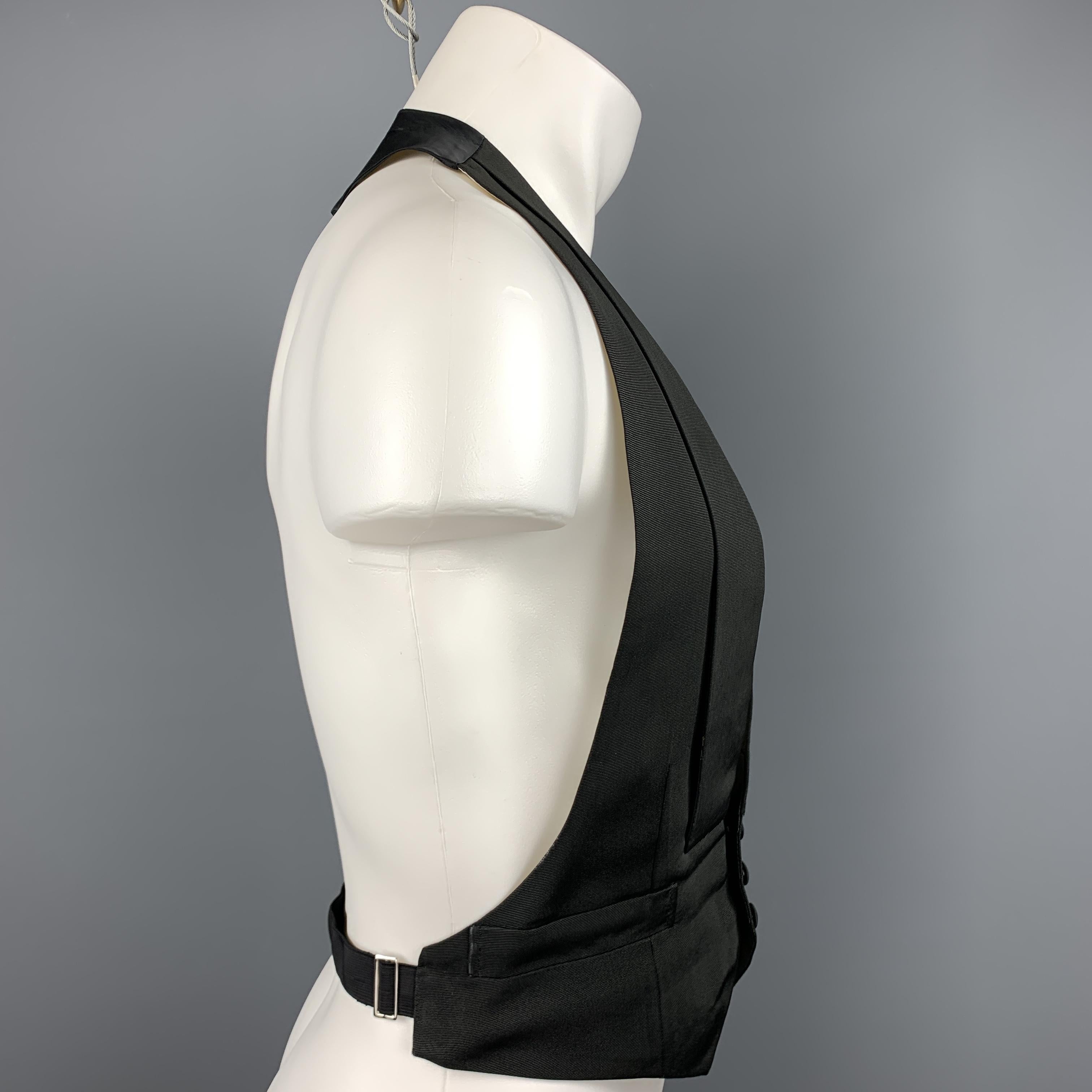 Custom Made HENRY POOLE & CO of Savile Row tuxedo vest comes in a black silk featuring a shawl lapel style, slit pockets, open back, and a buttoned closure. Made in England.

Excellent Pre-Owned Condition.
Marked: (No Size)

Measurements:

Shoulder: