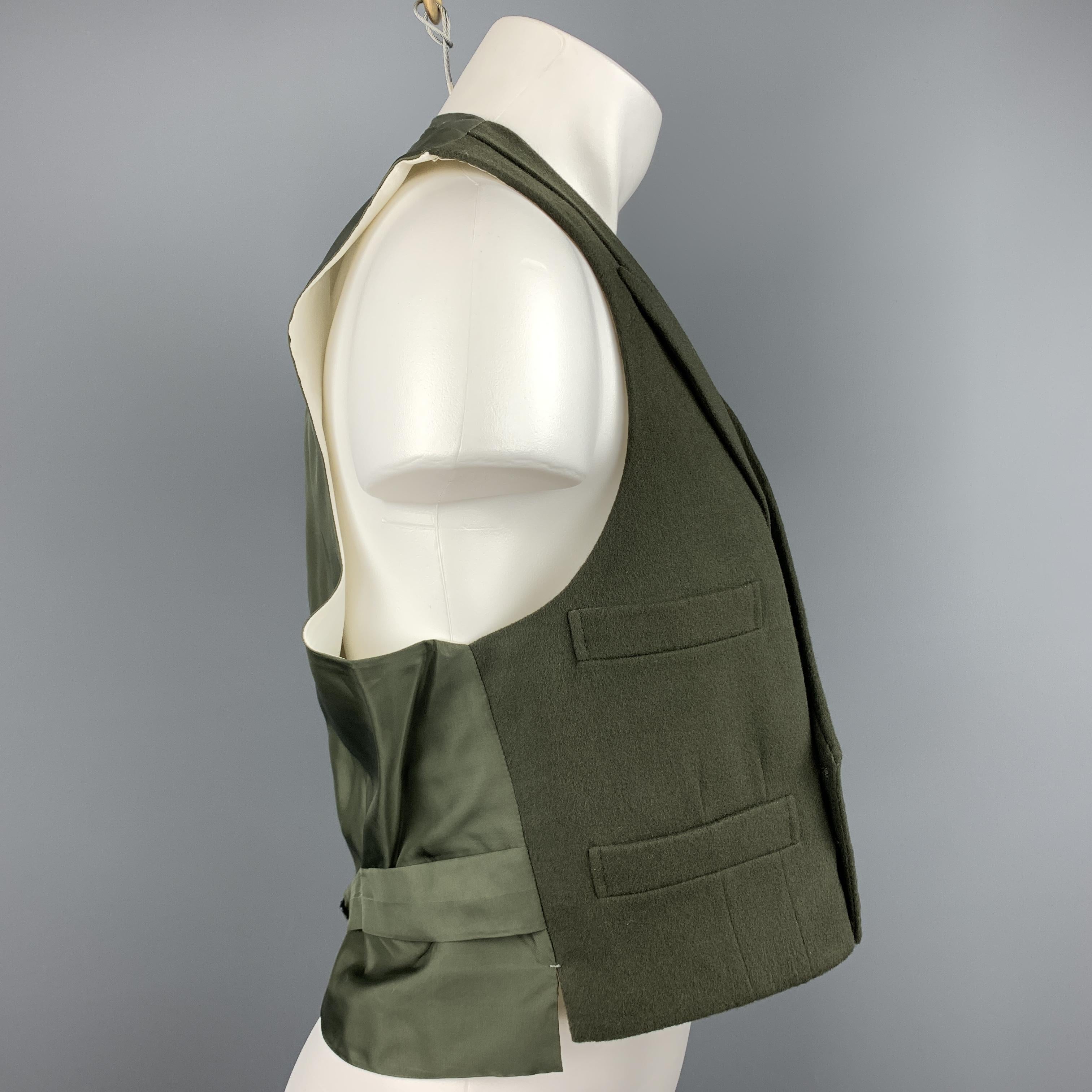 Custom Made HENRY POOLE & CO of Savile Row vest comes in a forest green wool featuring a peak lapel style, slit pockets, back belt, and a double breasted closure. Made in England.

Excellent Pre-Owned Condition.
Marked: (No