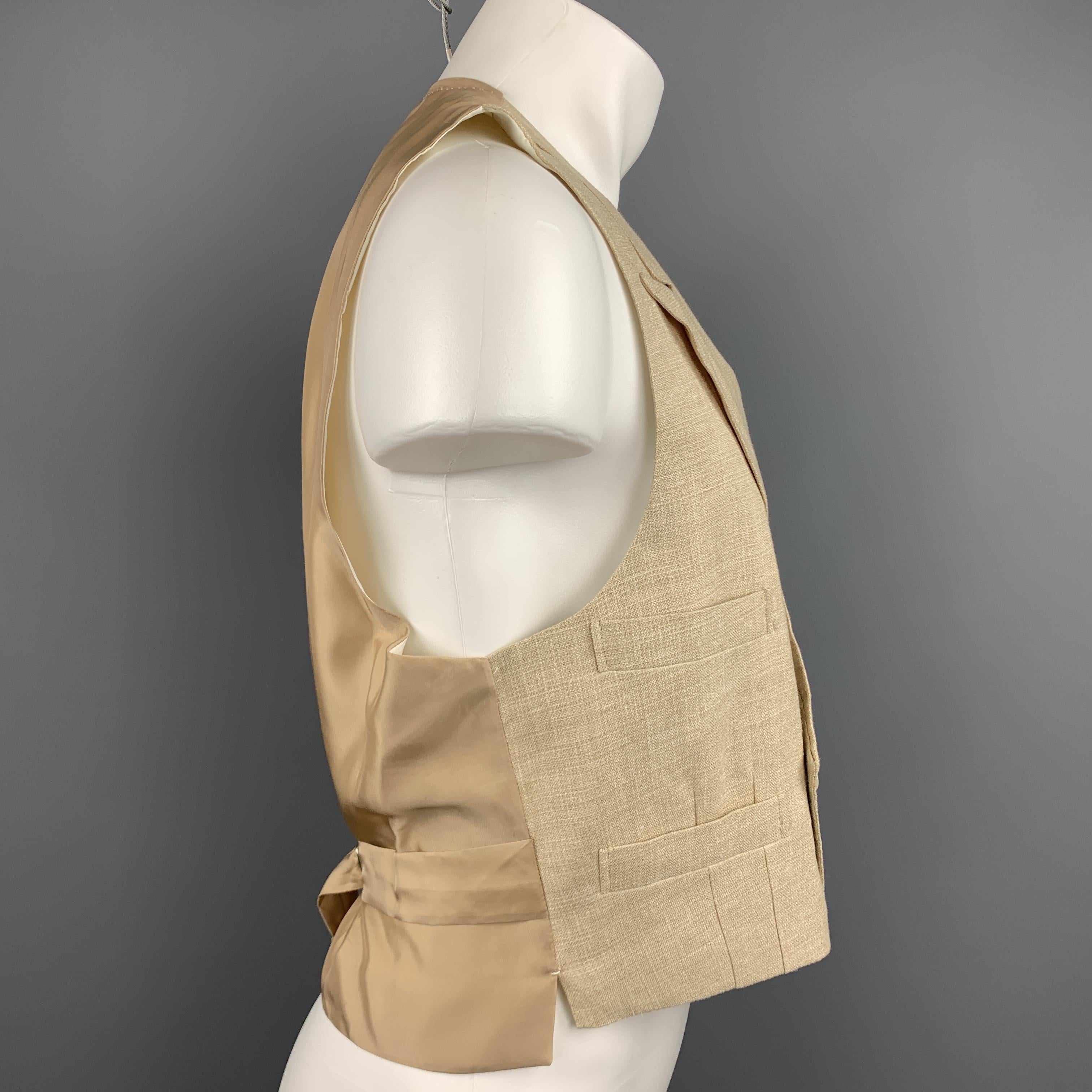 Custom Made HENRY POOLE & CO of Savile Row vest comes in a khaki woven linen featuring a peak lapel style, slit pockets, back belt, and a double breasted closure. Made in England. 

Excellent Pre-Owned Condition.
Marked: (No