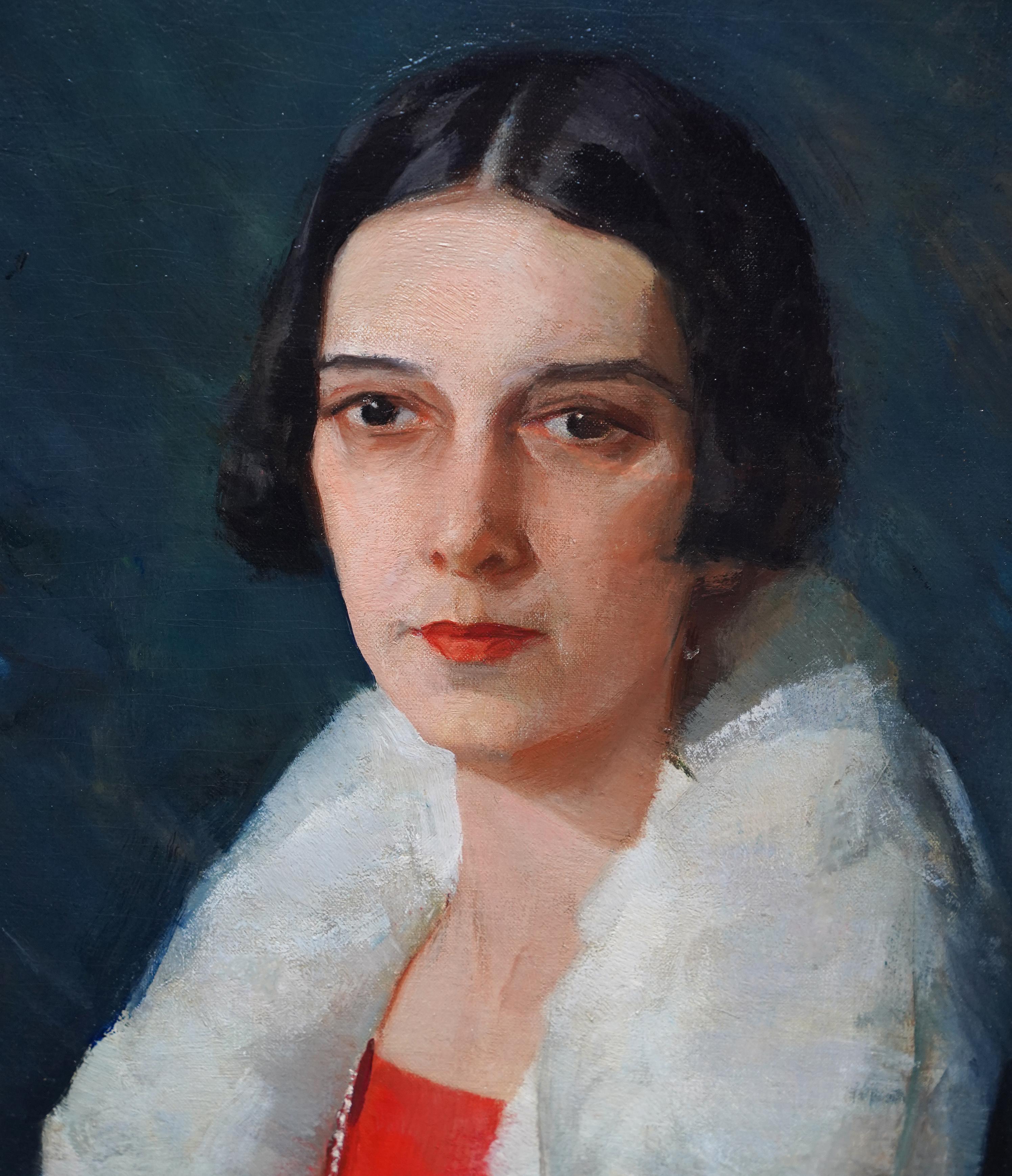 American artist Henry R Rittenberg painted this lovely 1920's Art Deco portrait oil painting. The painting is a standing half length portrait of a lady in a black coat with a white fur collar over a red dress and long beads. She has an elegant