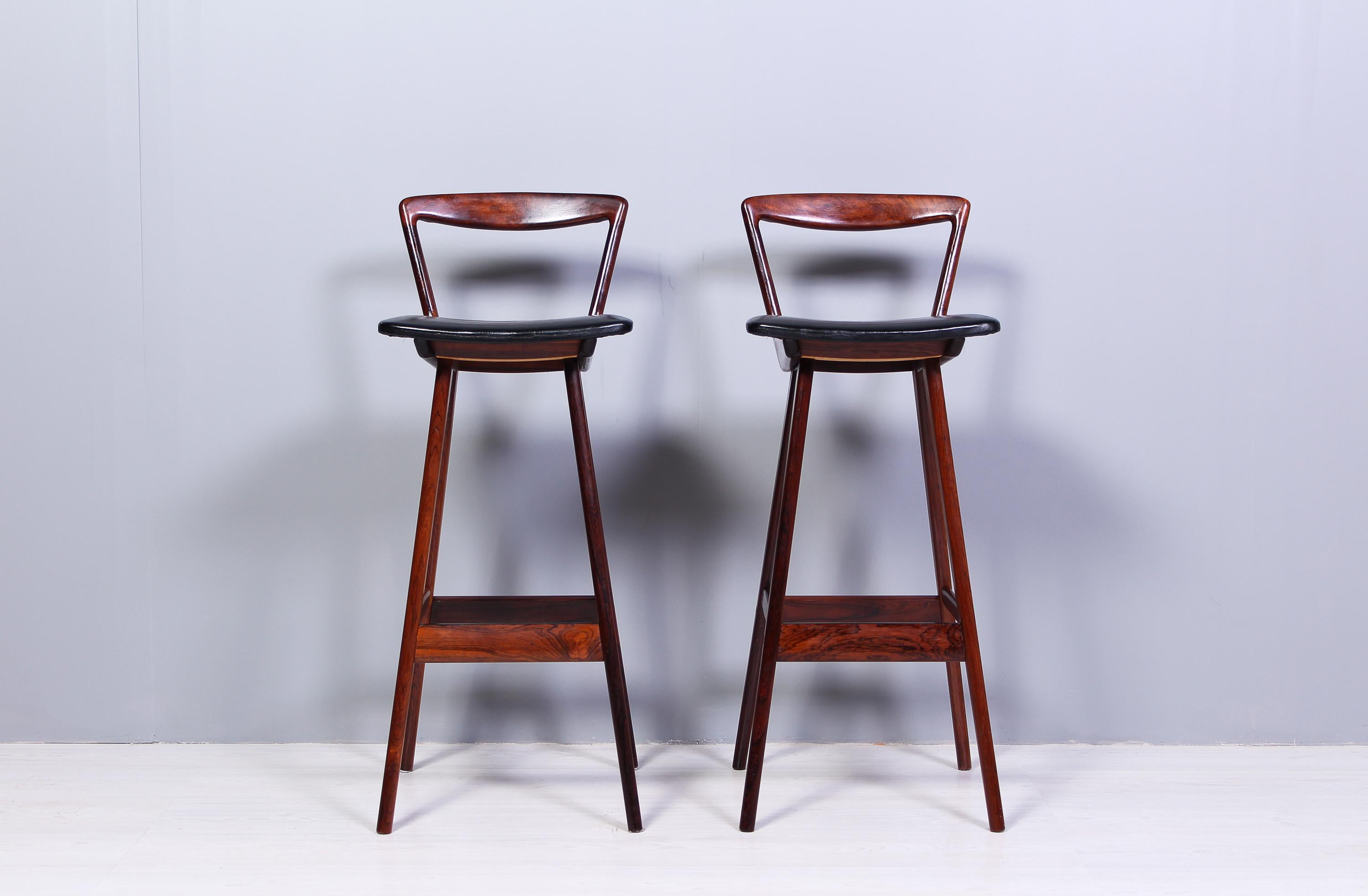 A very rare set of two rosewood bar stools by Danish designer Henry Rosengren Hansen. The stools were produced by Brande Møbelfabrik in Denmark during the 1950s. The chairs are in very good vintage condition with signs of usage consistent with age.