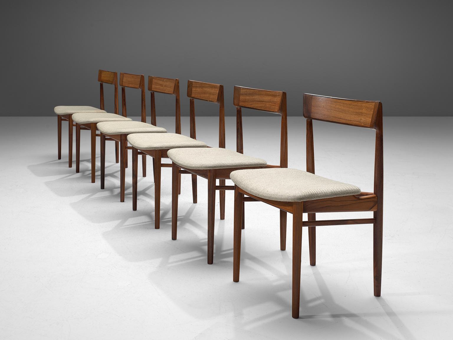 Henry Rosengren Hansen, dining chairs model 39, rosewood and fabric, Denmark, 1960s.

This wonderful crafted set of six dining chairs feature a solid rosewood frame. Danish designer Rosengren Hansen is known for high quality and very refined