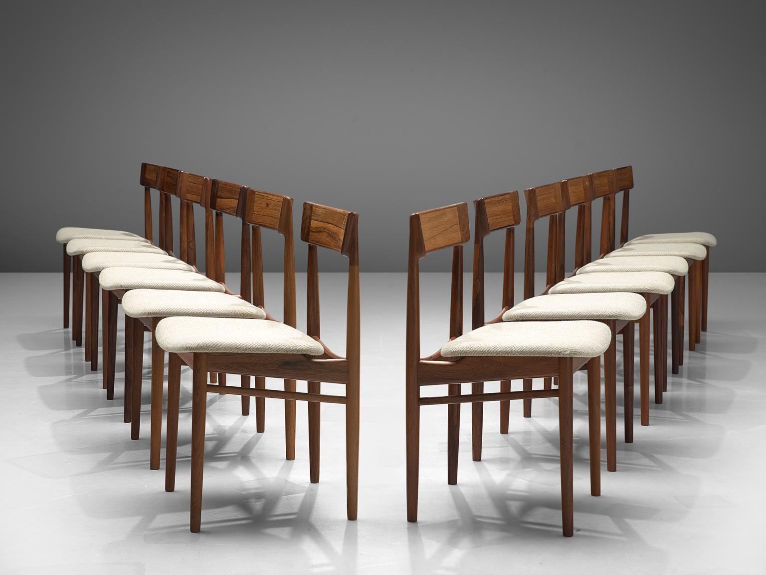 Henry Rosengren Hansen, 12 dining chairs model 39, rosewood and fabric, Denmark, 1960s.

This wonderful crafted set of twelve dining chairs feature a solid rosewood frame. Danish designer Rosengren Hansen is known for high quality and very refined