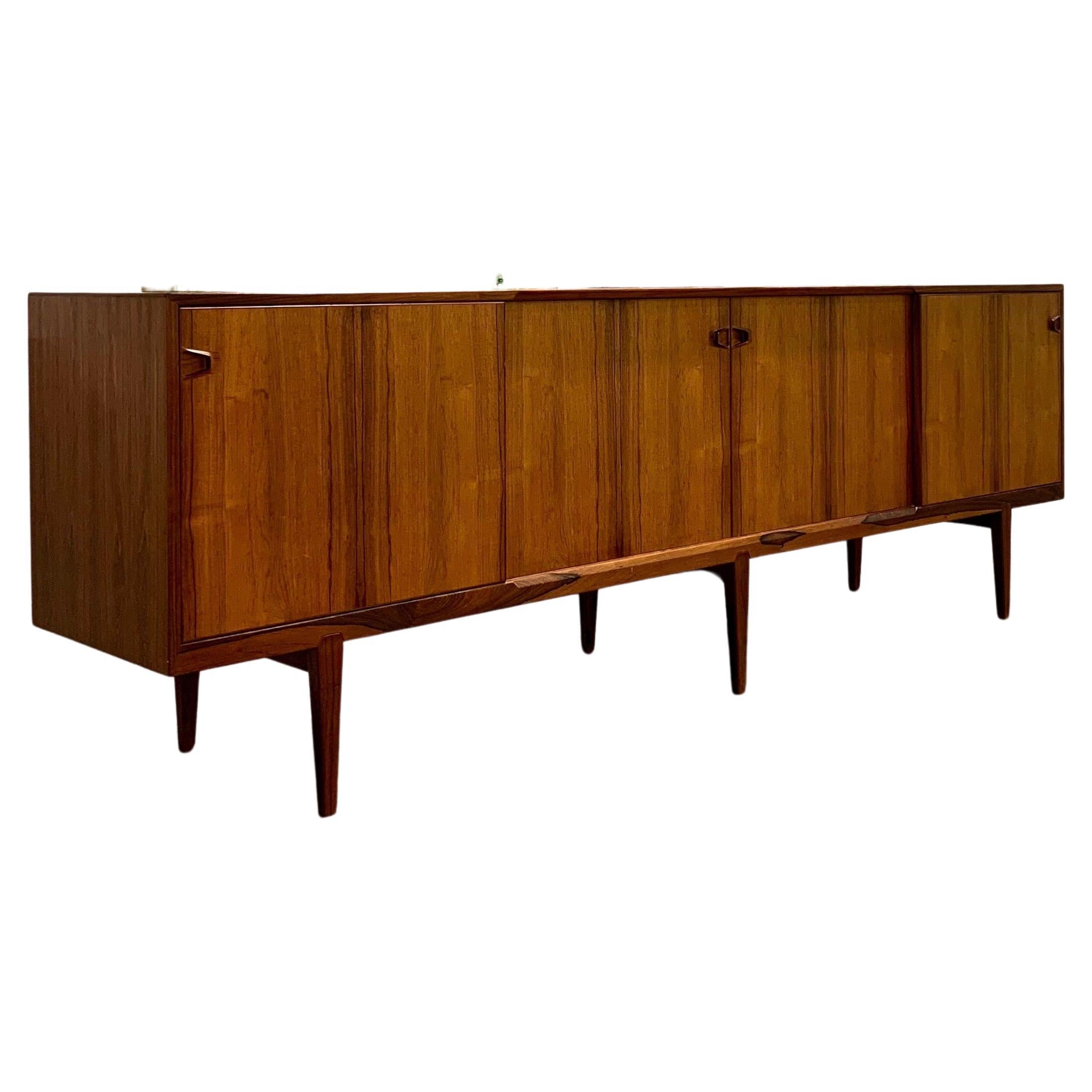 Beautiful rosewood sideboard designed by Henry Rosengren Hansen, model No 49, produced by Brande Møbelindustri in Denmark, 1960s.

This piece has so many well crafted details, the handles alone are sensational. It comes with a five drawers