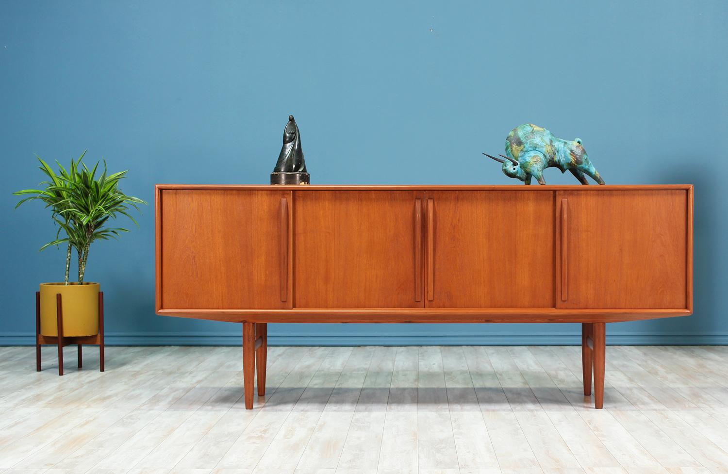 Spacious Danish Modern teak credenza designed by Kurt Østervig for Brande Møbelindustri in Denmark circa 1950’s. The subtle minimalistic details on this teak credenza reflect the expert craftsmanship put into making this design. The front features