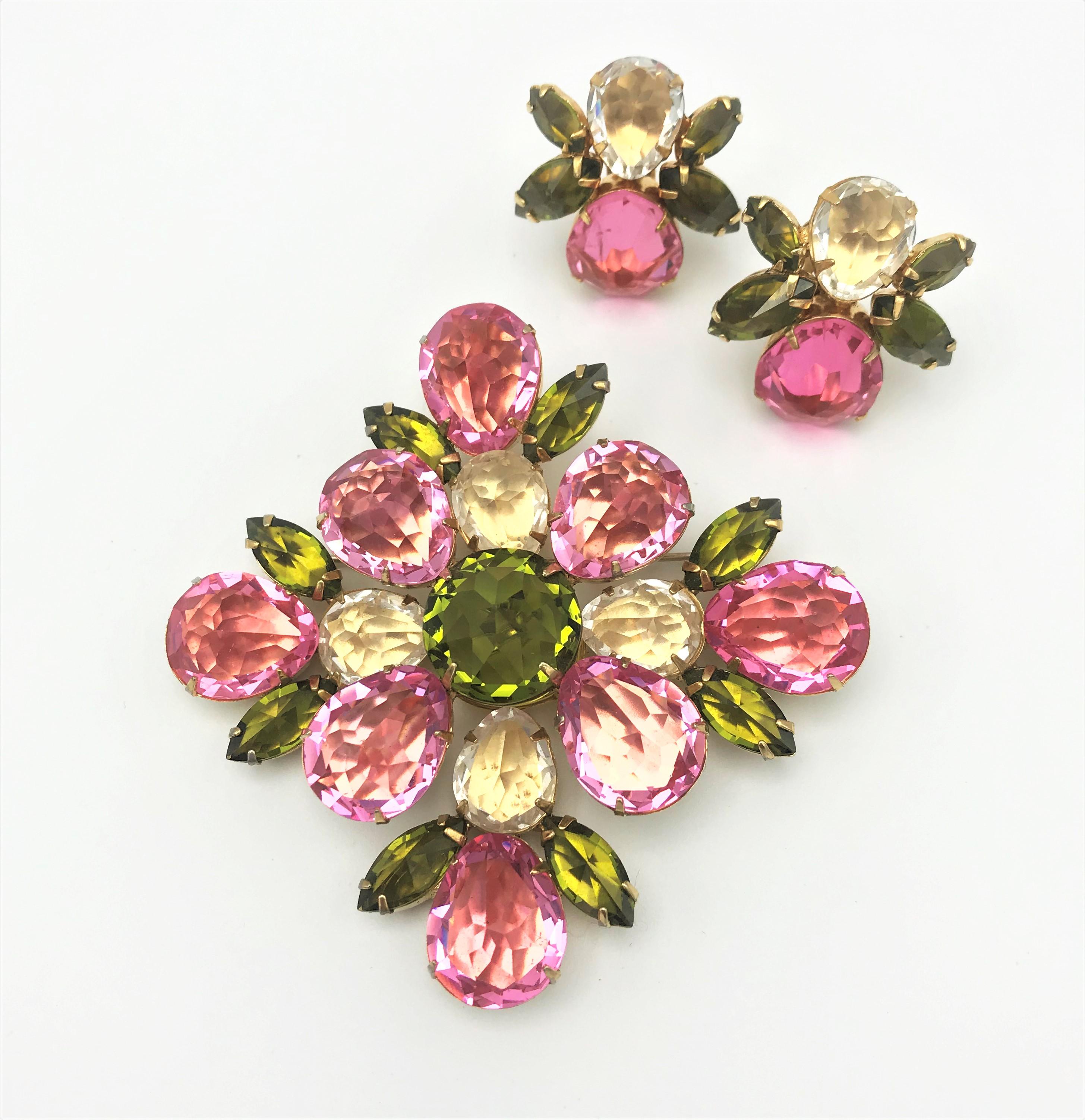 Wonderful brooch with large cut rhinestones in pink, olive green and clear. The matching ear clips in the same colors. Both pieces are signed 