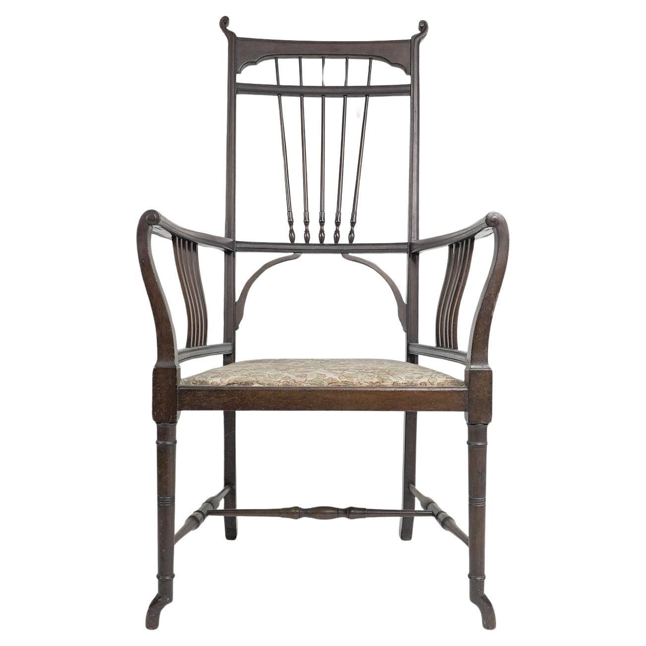 Henry W Batley attr. Poltrona in noce dell'Aesthetic Movement con tocchi sinuosi.