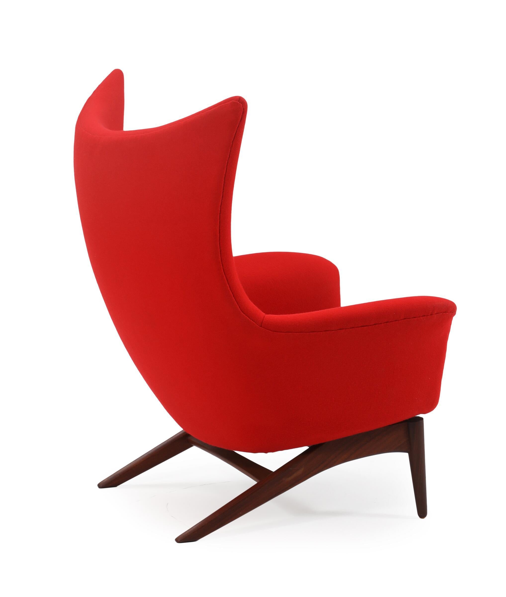 Henry W. Klein. Easy chair with teak rocking frame, upholstered with red wool. Manufactured by NA Jorgensens Mobelfabrik/Bramin. 1960's.

Feel free to request a delivery rate and we will do our best to search for the most reasonable quote.