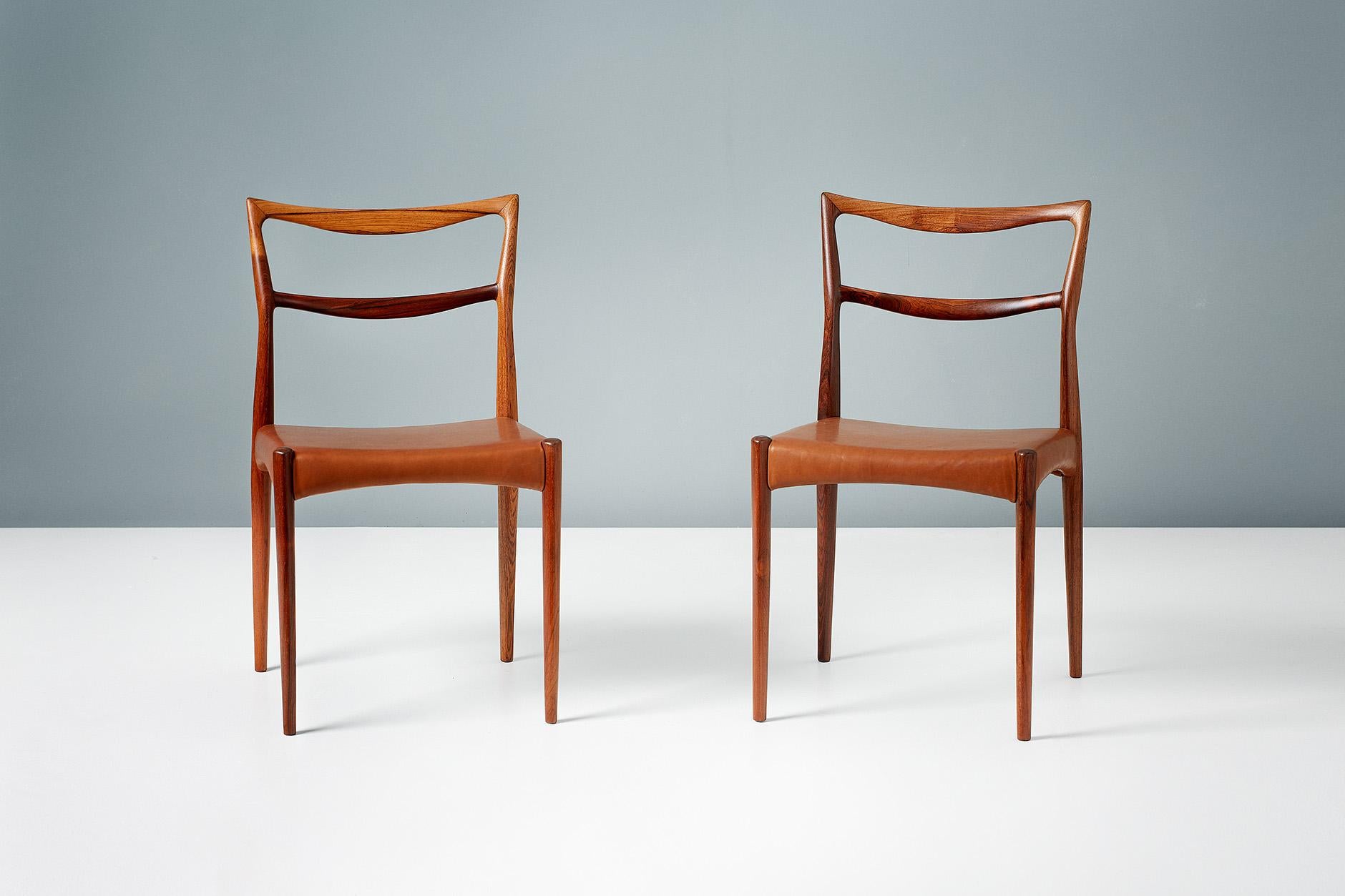 Rarely seen, sculptural dining chairs from Norwegian designer Henry W. Klein. Produced by Bramin in Denmark in exquisite Brazilian rosewood. The seats have been reupholstered in premium aniline cognac brown leather.
 
  