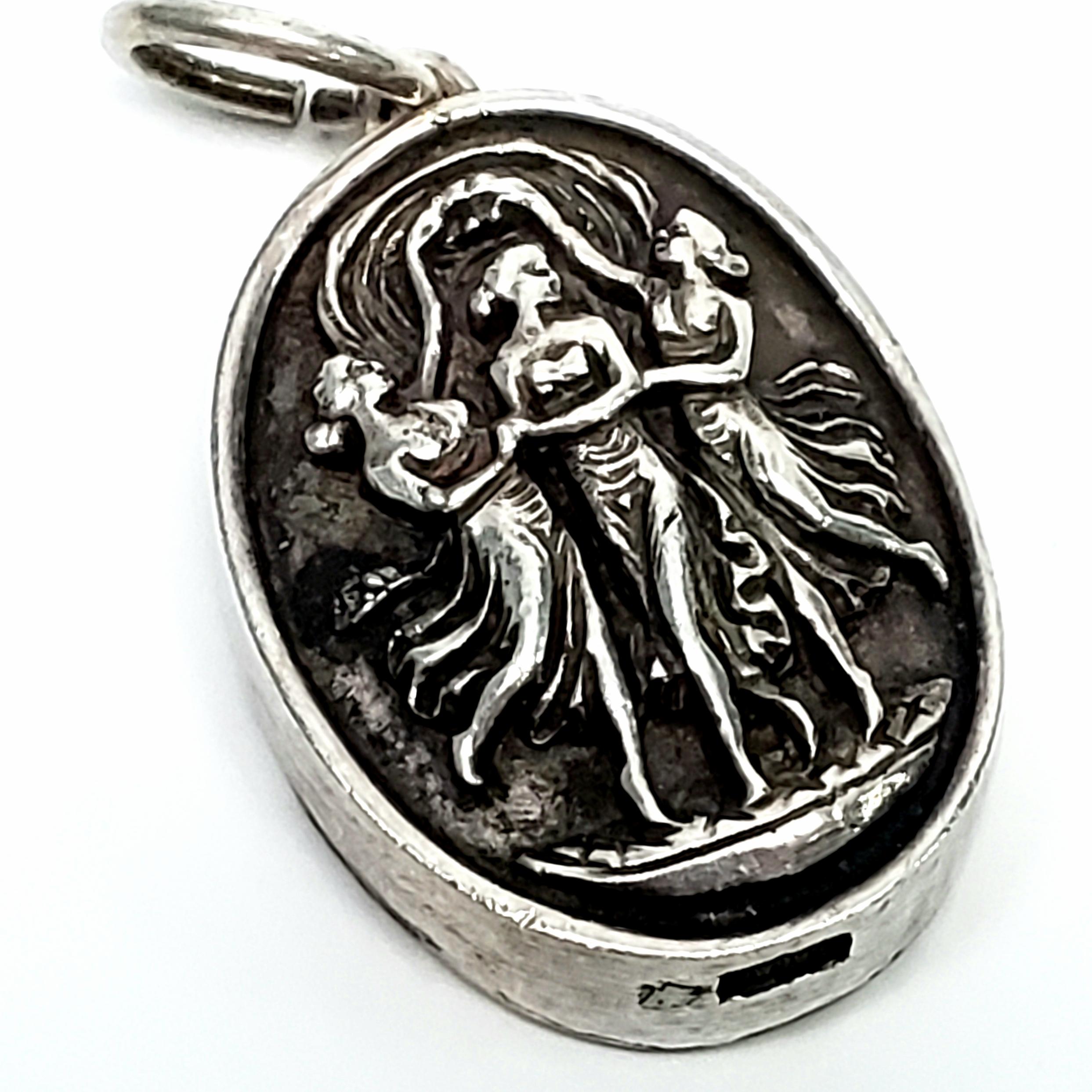 Vintage sterling silver pendant by Henryk Winograd featuring 3 ladies dancing.

Henryk Winograd was a leader in America in the art of Repousse. He used sheets of fine silver and hand crafted sharp, high relief designs. His work is highly