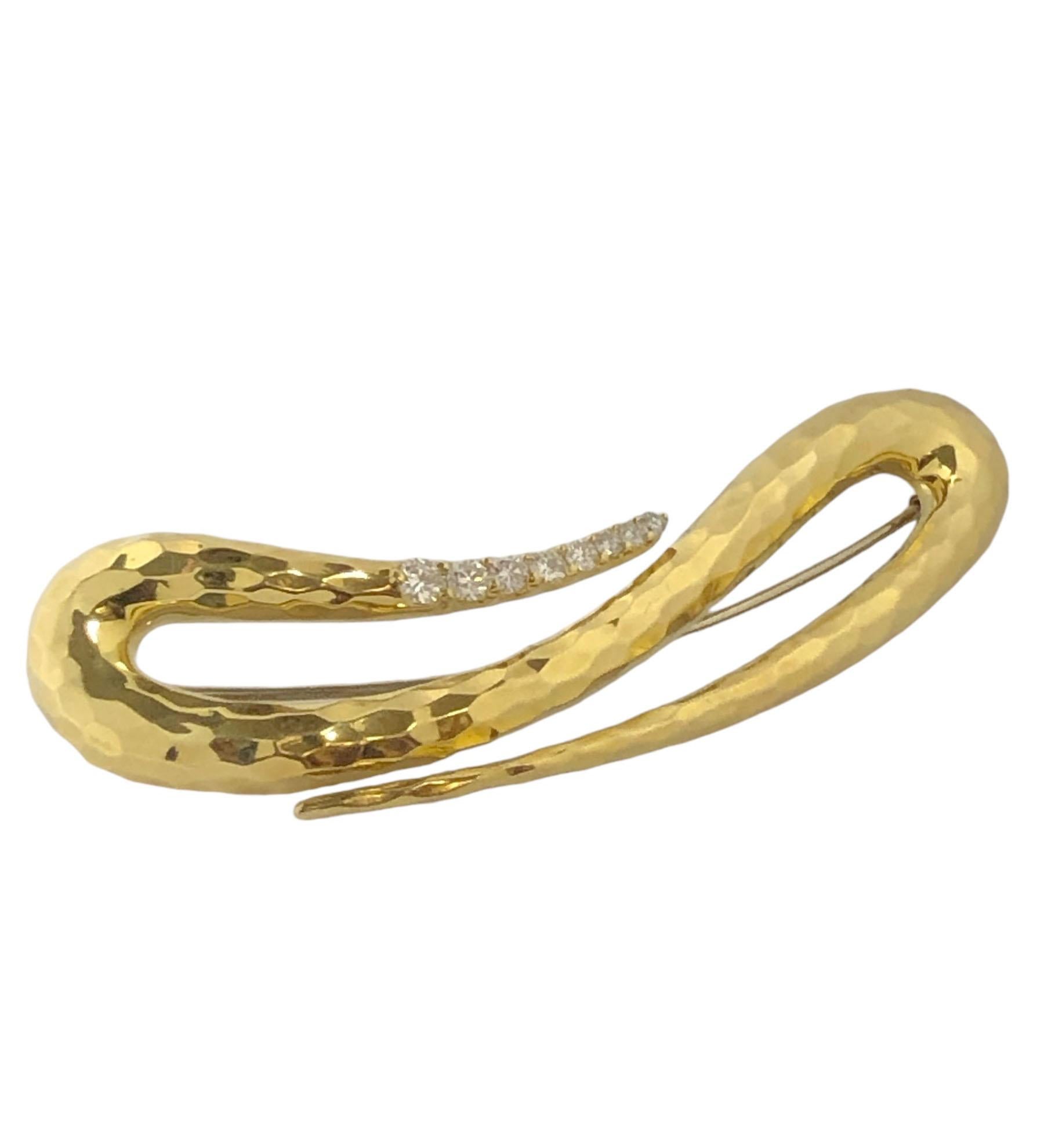 Circa 2000 Henry Dunay 18k Yellow Gold Hand Hammered Brooch, measuring 3 1/4 inches in length, 1 inch wide and weighing 30.9 Grams, set with Round Brilliant cut Diamonds totaling .65 Carat. 