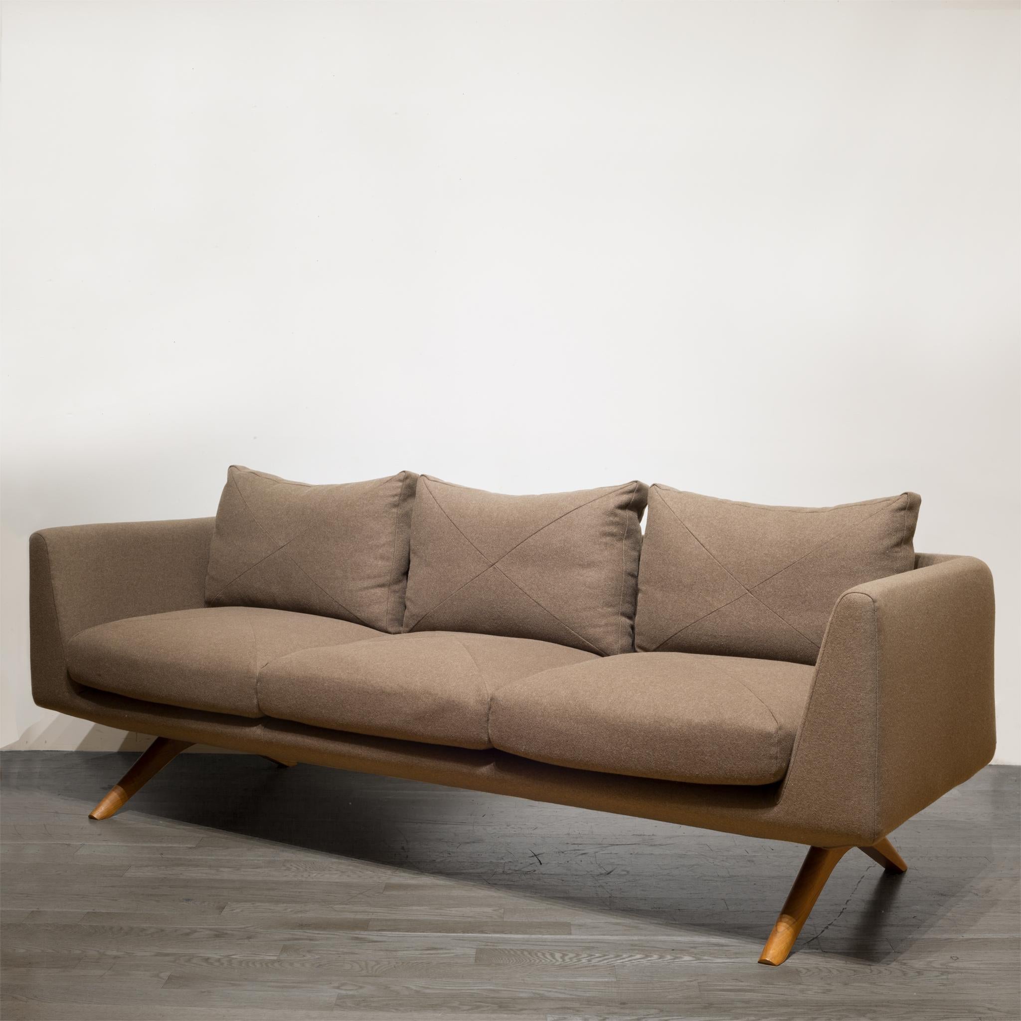 About

This is the Hepburn 3-seat sofa by De La Espada designed by Matthew Hilton. This sofa has custom cross detail on the cushions in an espresso wool fabric. The unique and elegant wooden legs are a Danish oiled American black walnut. This sofa