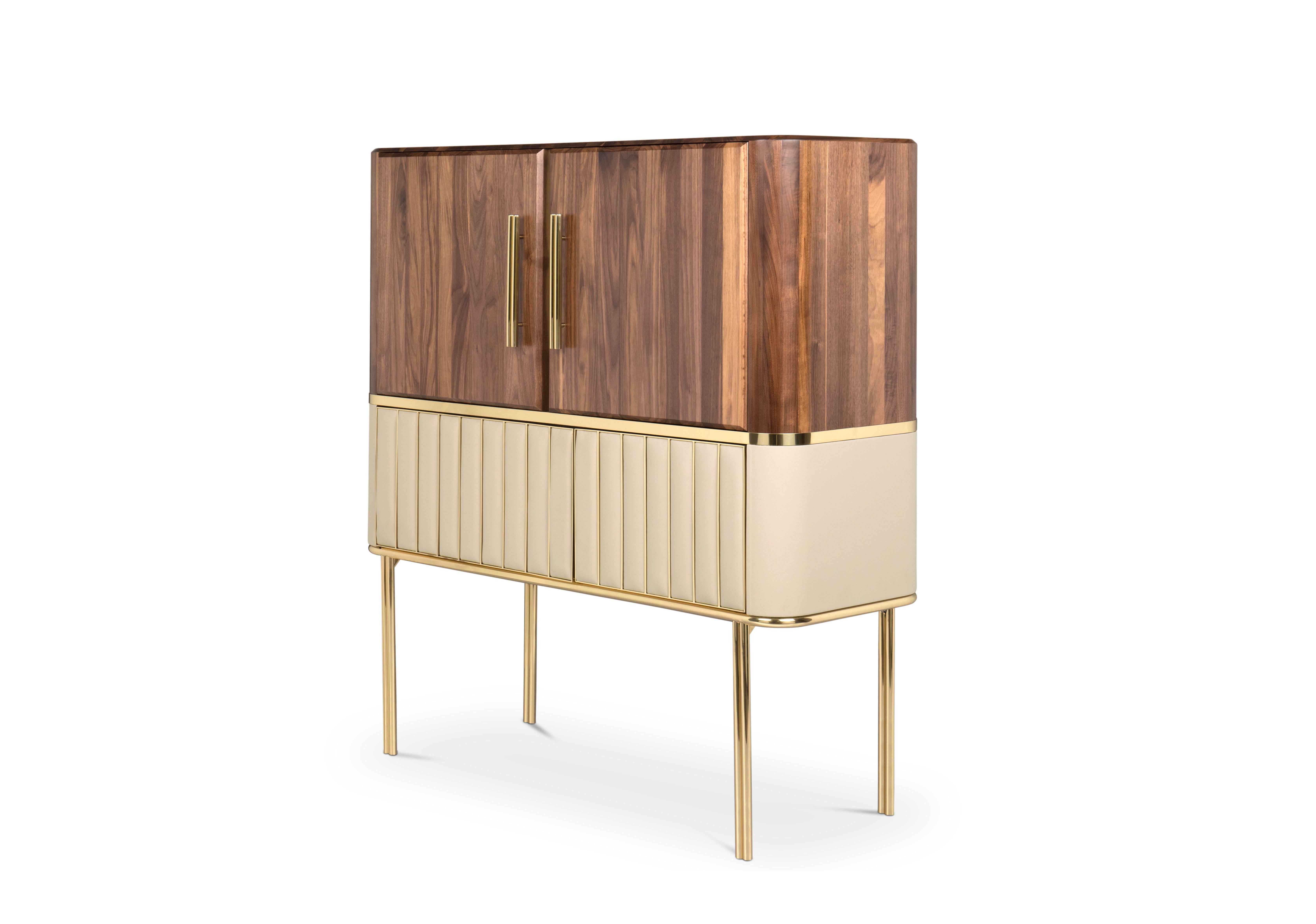 Inspired by one of the most refined names in the Hollywood industry, Essential Home created Hepburn cabinet. With a body handmade in walnut and two door handles made of polished brass, this mid-century modern cabinet stands out thanks to its leather