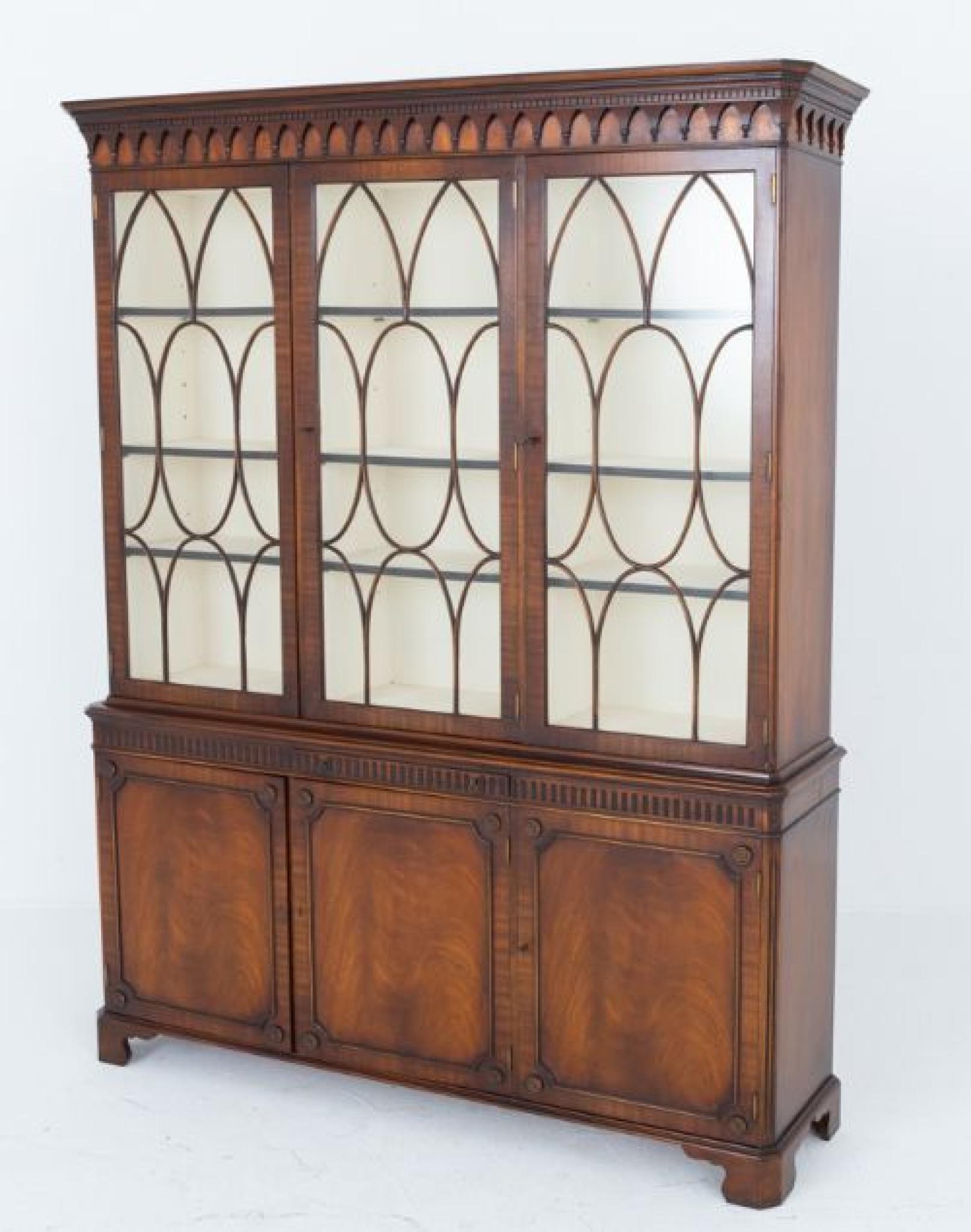 Mahogany Hepplewhite style bookcase
This bookcase stands upon bracket feet
Circa 1920
Having 3 lower cupboards which feature wonderful flame mahogany , astragal moldings and carved rosettes to the corners
The frieze above the doors having carved