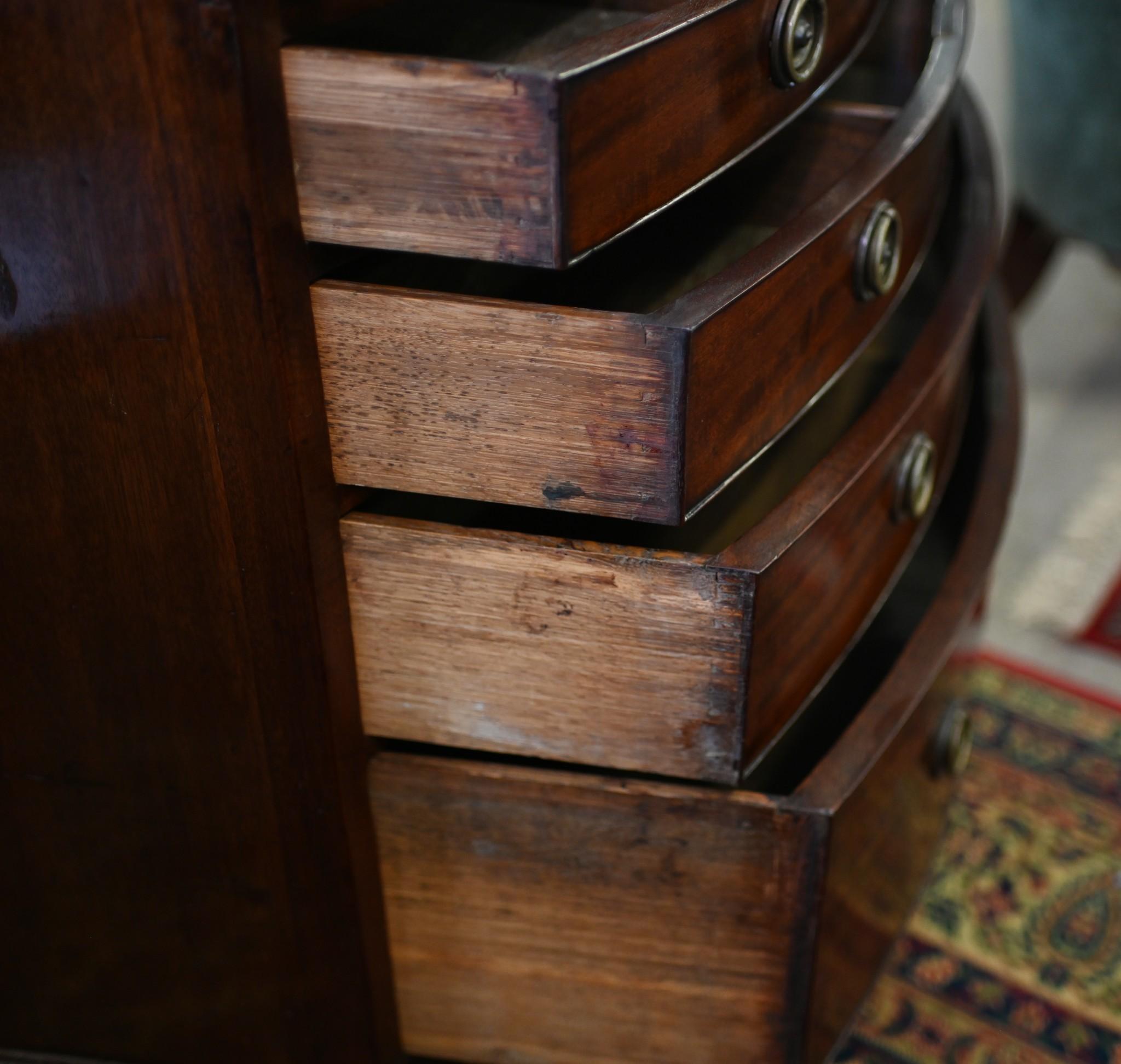 Gorgeous antique mahogany bow front chest of drawers after Hepplewhite
Features a pull out brushing slide - this functioned as a surface to brush clothes before wearing
Below that are four drawers that get bigger as they go down, so ample