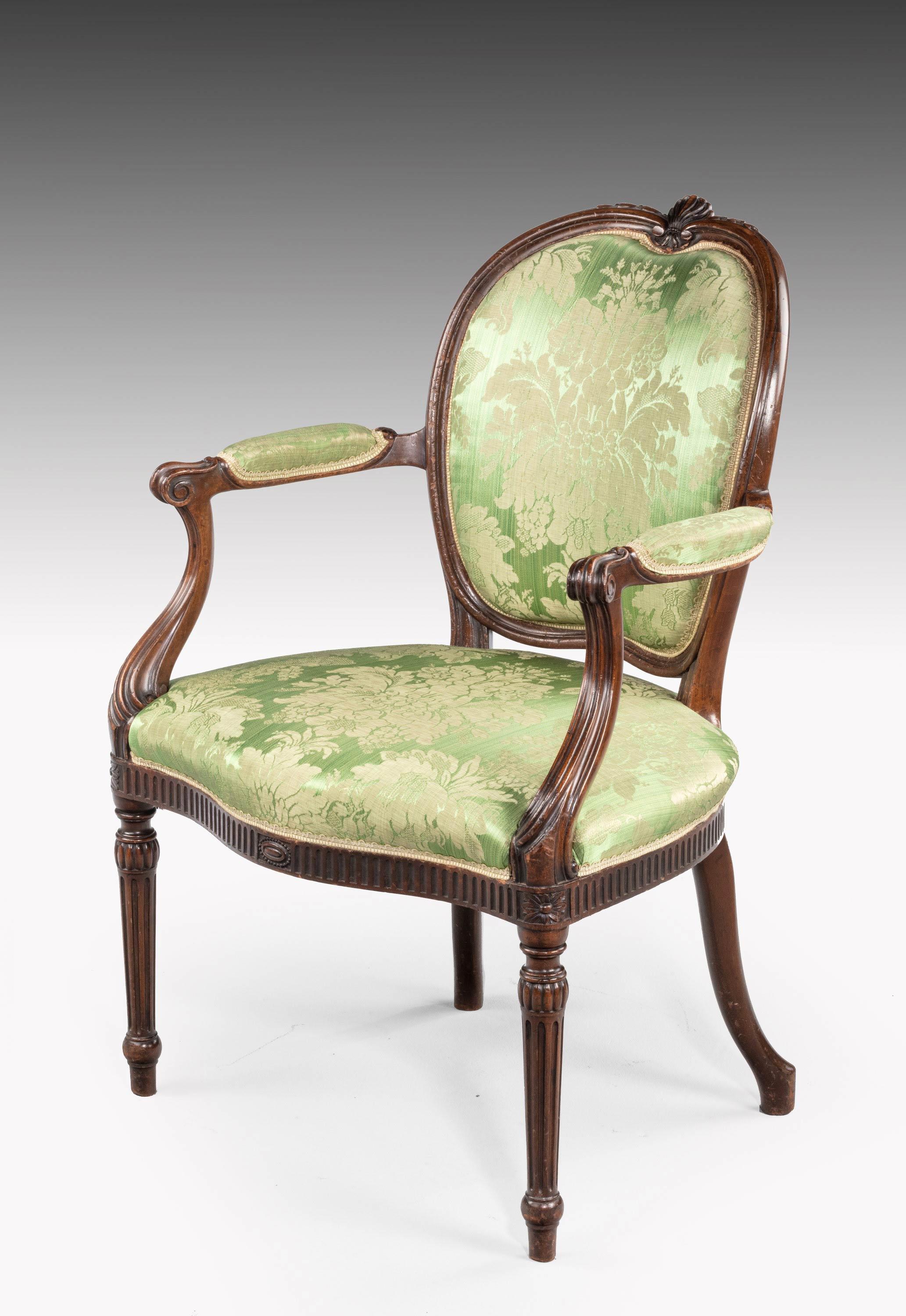 An extremely elegant mahogany framed chair of Hepplewhite design. The heart shaped back with beautifully executed cartouche carving to the top involving a stretched anthemiom leaf.
 