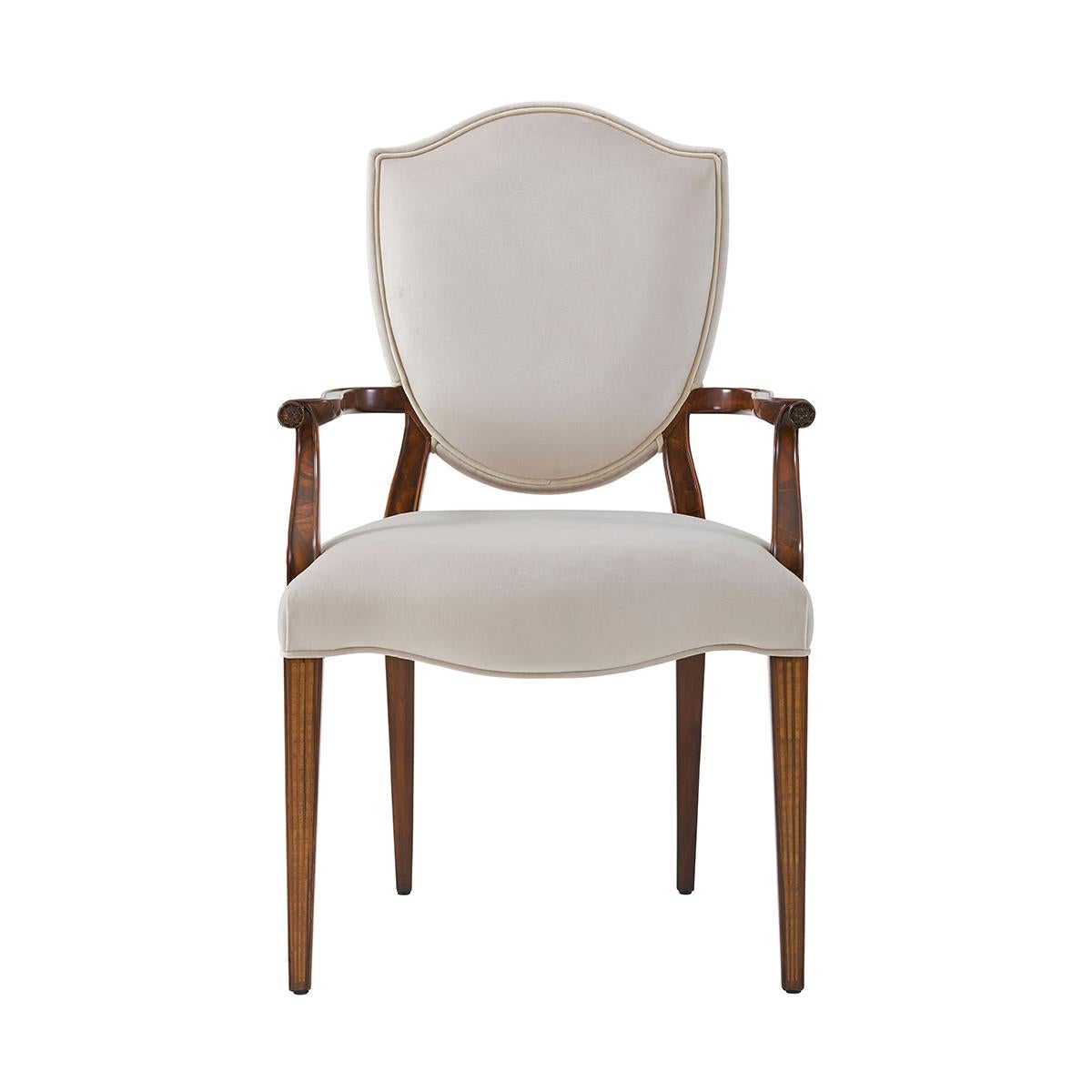 Two George III Hepplewhite style shield back armchairs, with an upholstered back with flame mahogany veneered back Supports and scroll arms with rosette terminals, the upholstered seat on square tapering legs with satinwood faux fluted