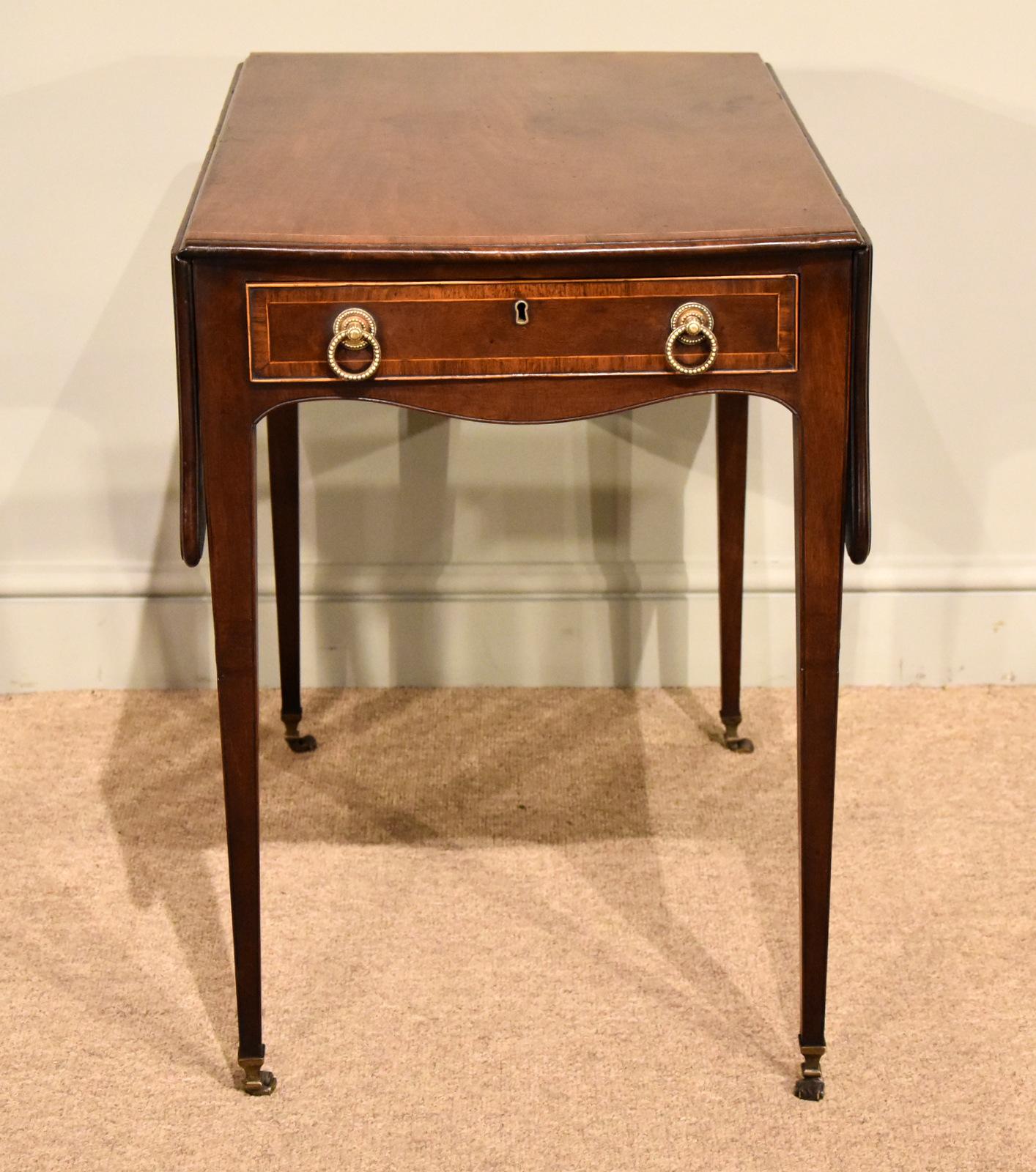 A very fine Hepplewhite fiddleback mahogany butterfly Pembroke table. Original handles leather casters and brass caps. Great color and patina

Measures: Height 28