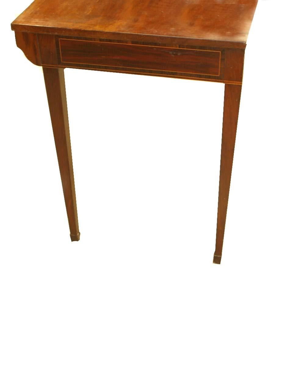 Hepplewhite mahogany console table with beautiful figured top, the front and sides with flame mahogany veneer surrounded by a band of inlay, the front with central cartouche of satinwood; tapered legs terminating with delicate marlboro feet.