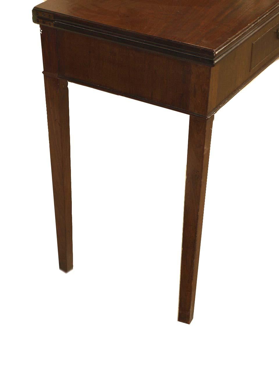 Hepplewhite mahogany game table, the hinged top folds over and is supported by the left rear leg that swings out. Beautiful mahogany playing surface above single drawer with original swan neck brass pull. This table with tapered legs has excellent