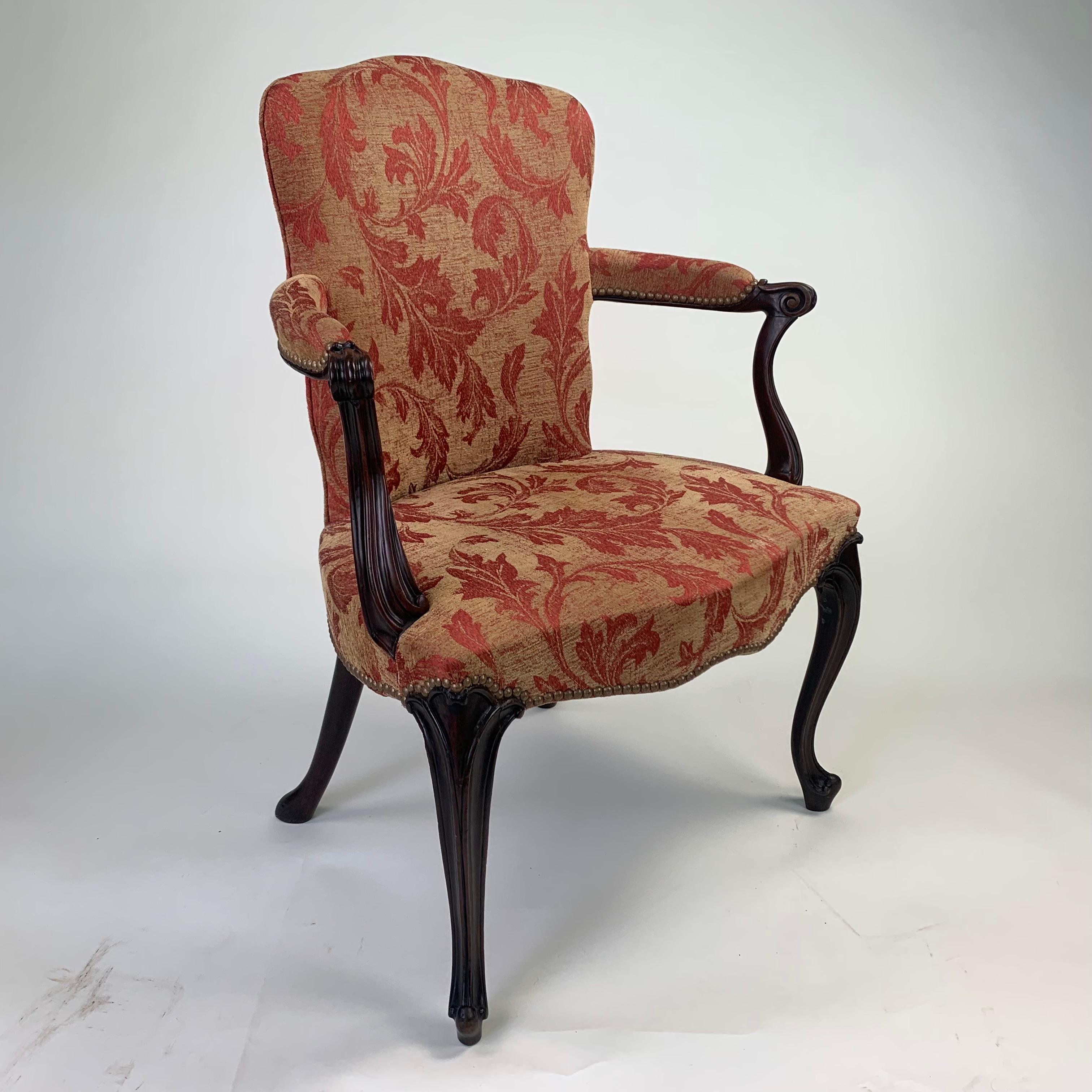 A high quality late 18th century English salon chair of “French Hepplewhite” design, with upholstered back and out-scrolled moulded arms, standing on shaped and moulded cabriole legs and scrolled toes with pad feet at the rear.