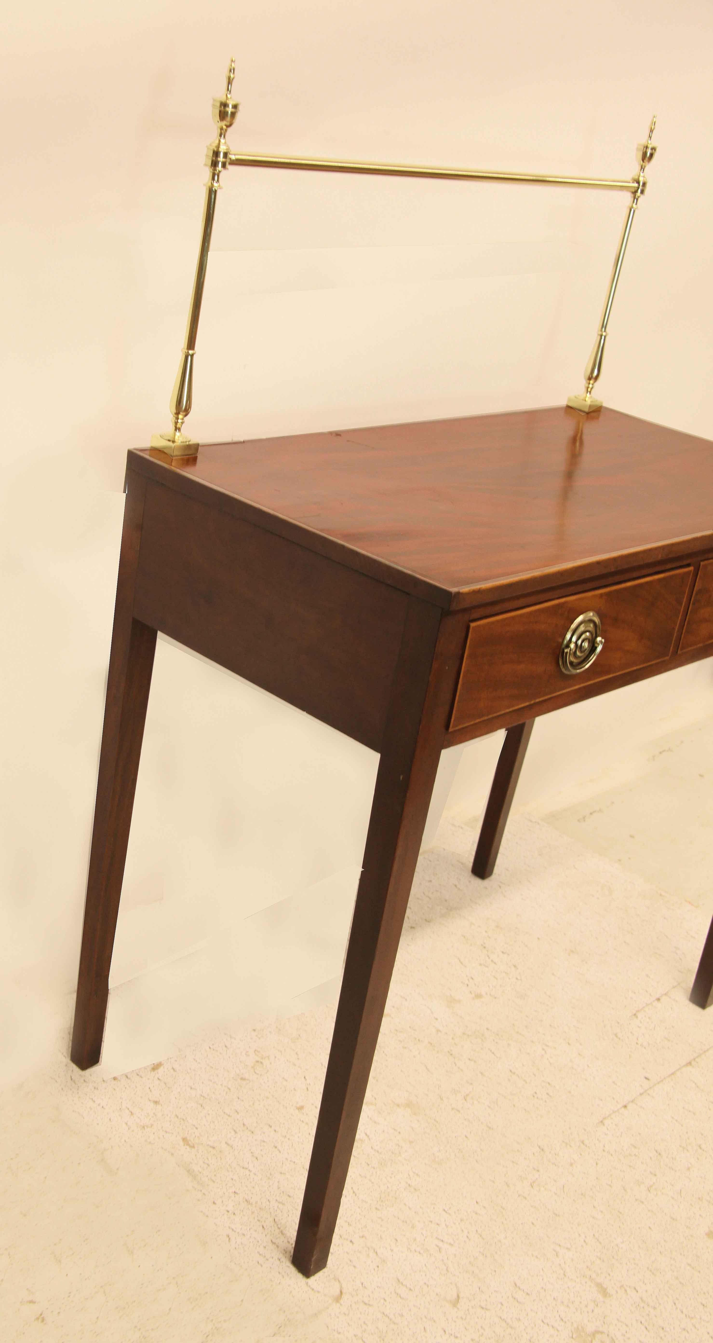 Hepplewhite serving table, the top with beautiful swirl grain mahogany has a string of boxwood inlay on the front edge, freshly polished and lacquered brass gallery at the back. The two drawers with hand made(not original) brass oval pulls,