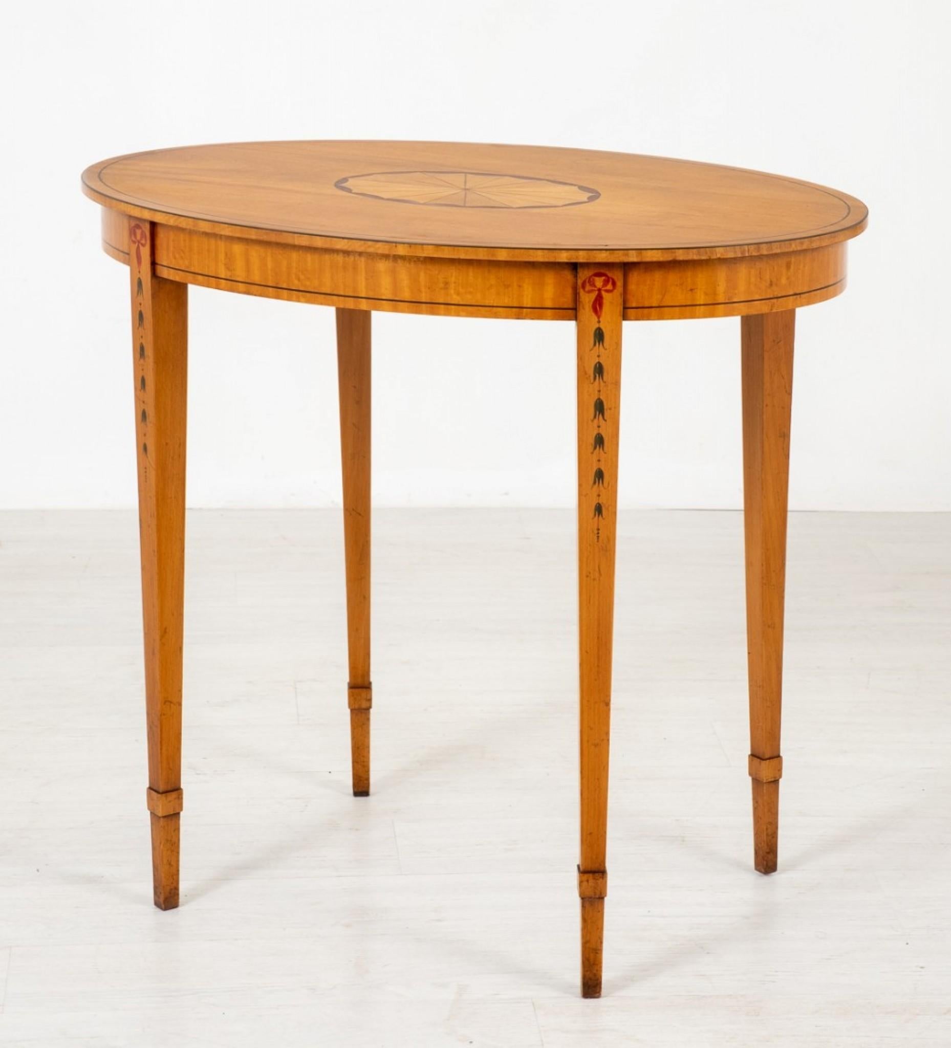 Hepplewhite style satinwood occasional table.
circa 1890.
This elegant table is raised upon tapered legs with painted harebell decoration.
The satinwood frieze having ebony line inlays .
The top of the table featuring a centralised inlaid