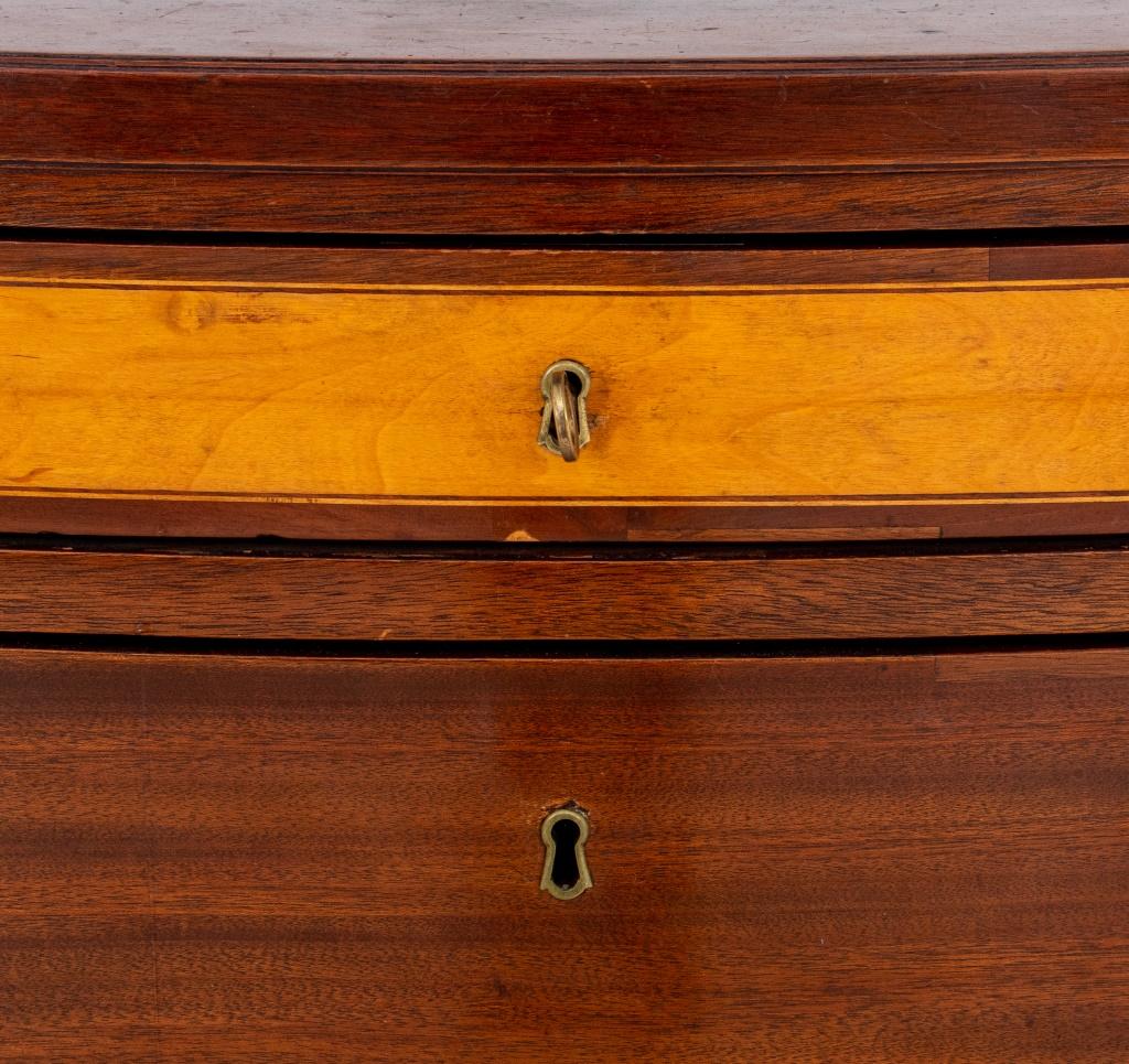Hepplewhite style inlaid mahogany chest of drawers, having bow front top with conforming four drawer case, raised on square fluted feet, likely nineteenth century.

Dimensions: 33