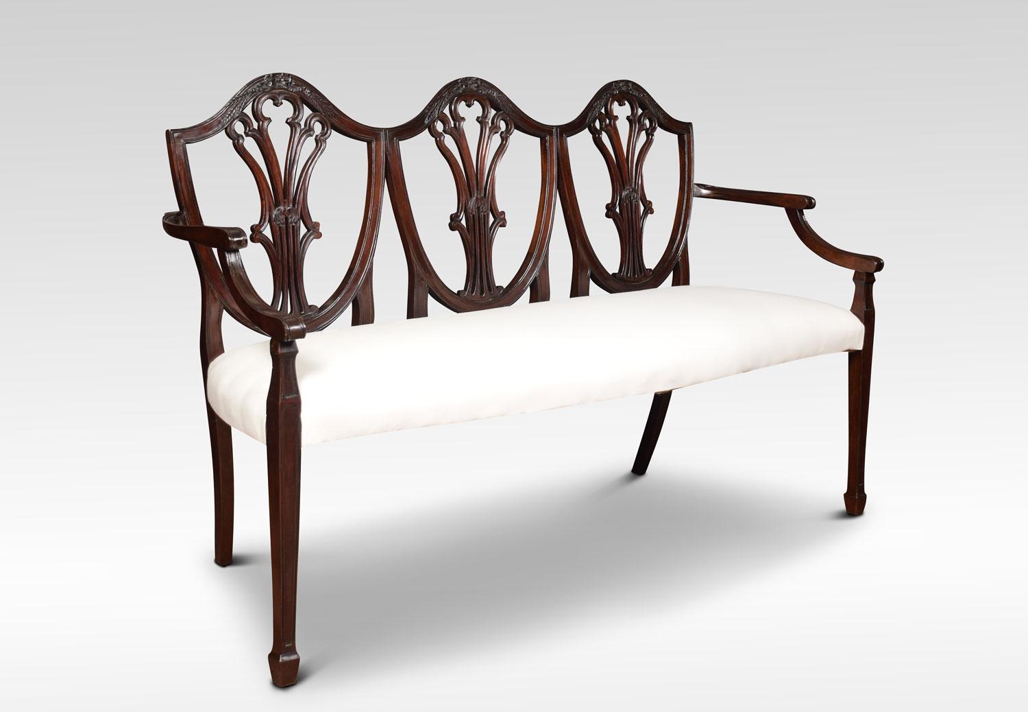 A Hepplewhite style settee, the triple mahogany shield shaped back with pierced wheat sheaf carved splats. To the overstuffed upholstered seat, flanked by out swept arms. All raised up on square tapering molded supports.
Dimensions:
Height 37