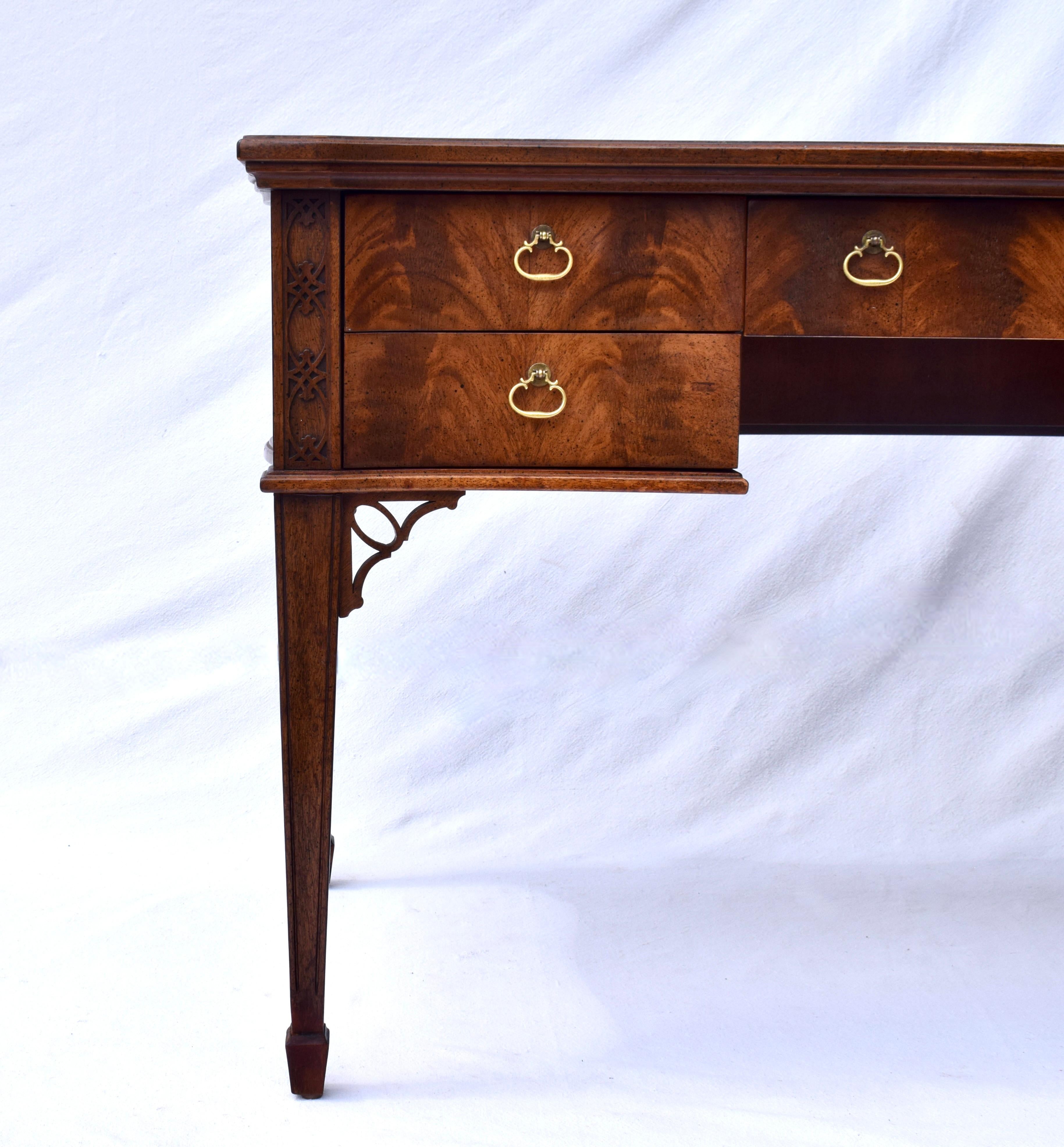 Hepplewhite style writing desk in Mahogany with serpentine front, marvelous carvings & fretwork, working lock, tapered legs and spade feet.  Age appropriate wear to the tooled leather top boasts distinct character to this lovely all original writing