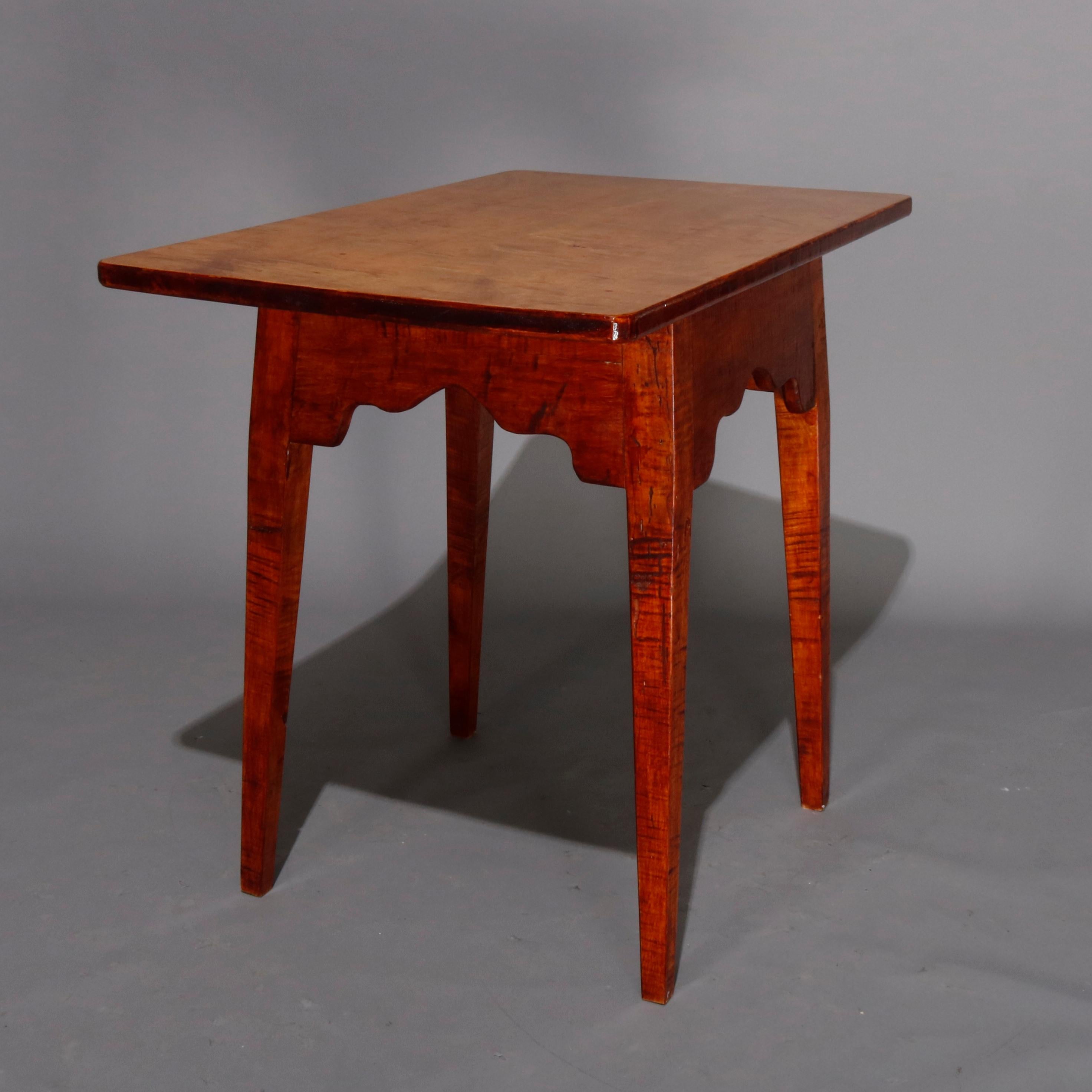 Hepplewhite style work table features tiger and bird's-eye maple construction with oversized work surface surmounting deep, shaped and flared apron and raised on tapered legs, 20th century

Measures: 30.25