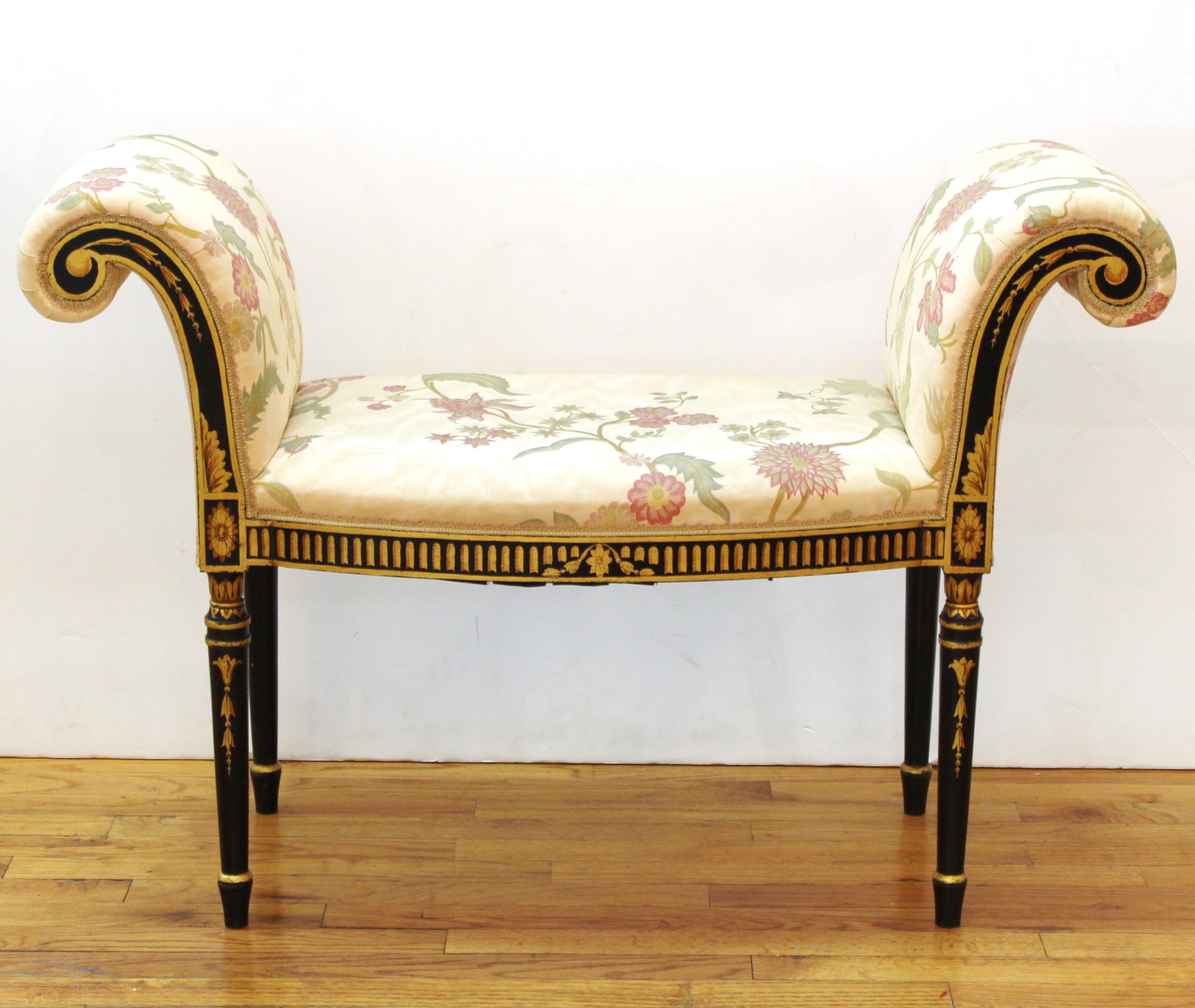 Hepplewhite style pair of upholstered window benches. The pair has decorative gold painted ornament on the front of its ebonized wood structure and scrolled armrests. In great vintage condition with age-appropriate wear and use.